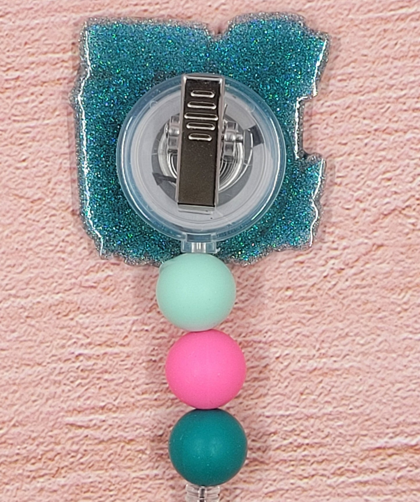 Introducing the new RN Badge Reel, part of our latest collection of Medical Badge Reels available now. Featuring a blue glitter base adorned with coordinating beads in shades of pink and blue, this Badge Reel is sure to catch the eye.