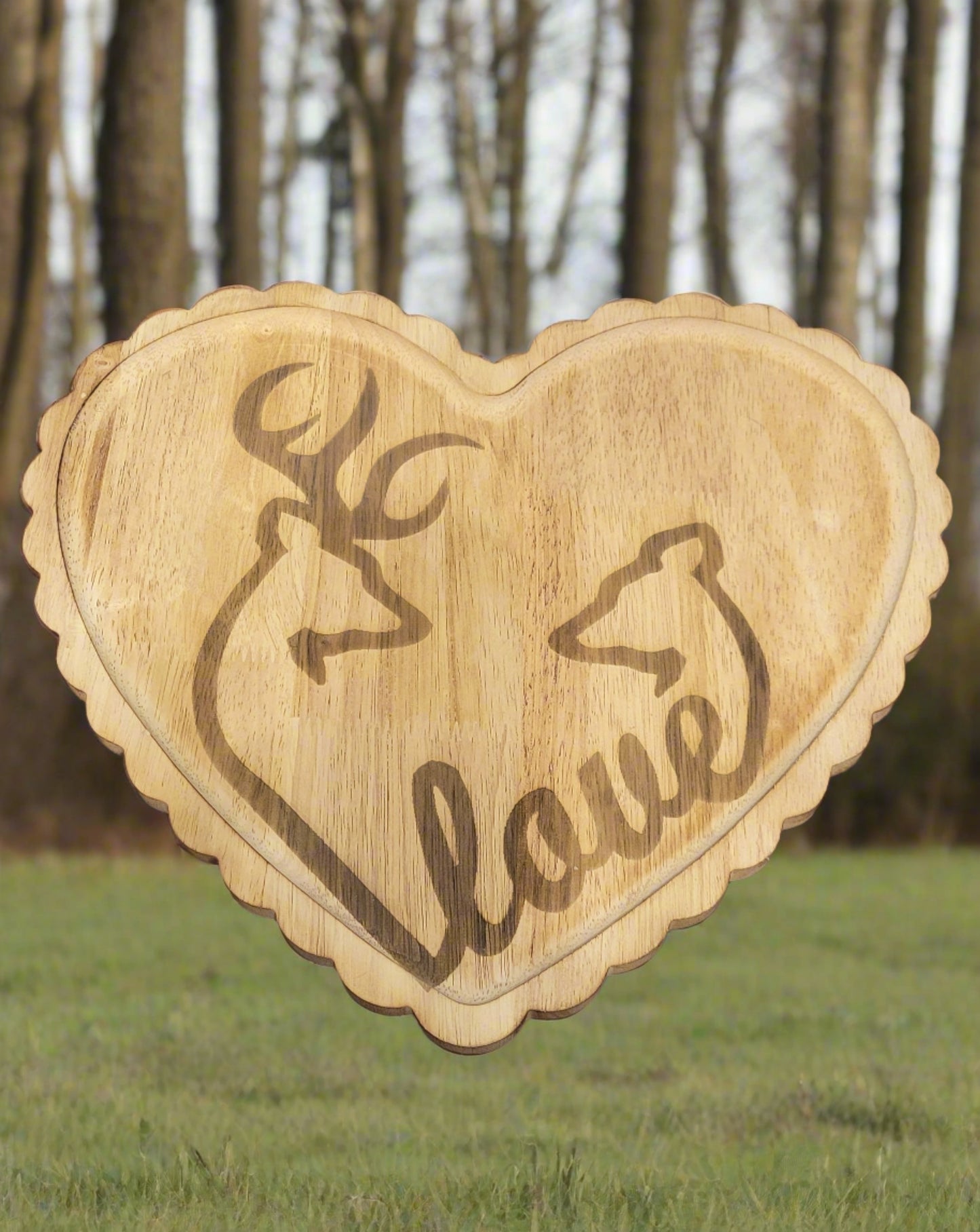 New to our lineup. This is a Heart Shaped Tray with the outline of a Buck & Doe linked with the word Love. Engraved on bamboo wood measuring 11" x 13" this beaty can be used as a wall hanging or a tray in any room.