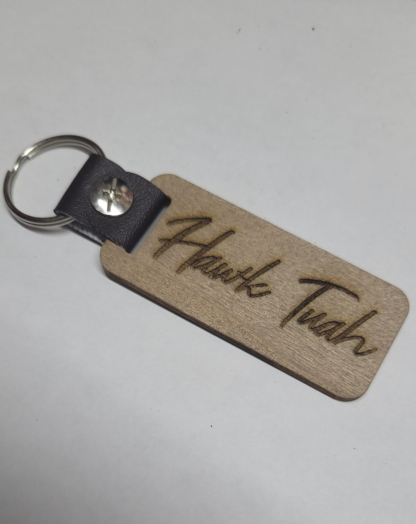 This Laser Engraved wood key chain sports the latest phrase.... Hawk Tuah. This on the front and Spit on That Thang on the back. For a fun novelty gift.... a must have