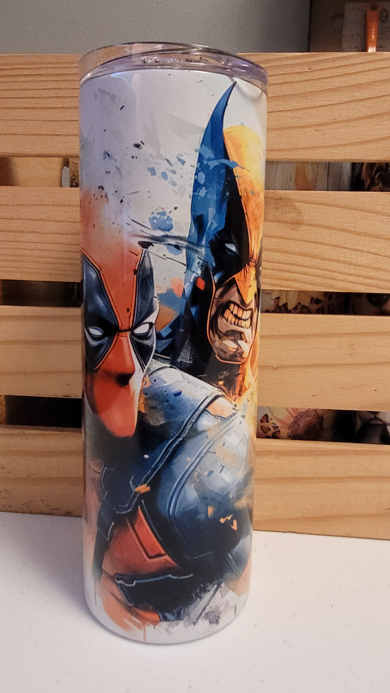 Deadpool & Wolverine...together finally! Here is a watercolor image of the pair. This 20 oz tumbler from Makerflo is made of a stainless steel double-wall construction and is vacuum insulated, with a clear sliding classic lid and a clear straw, and is BPA free. It is capable of retaining cold temperatures for 24+ hours or warm temperatures for up to 8 hours.