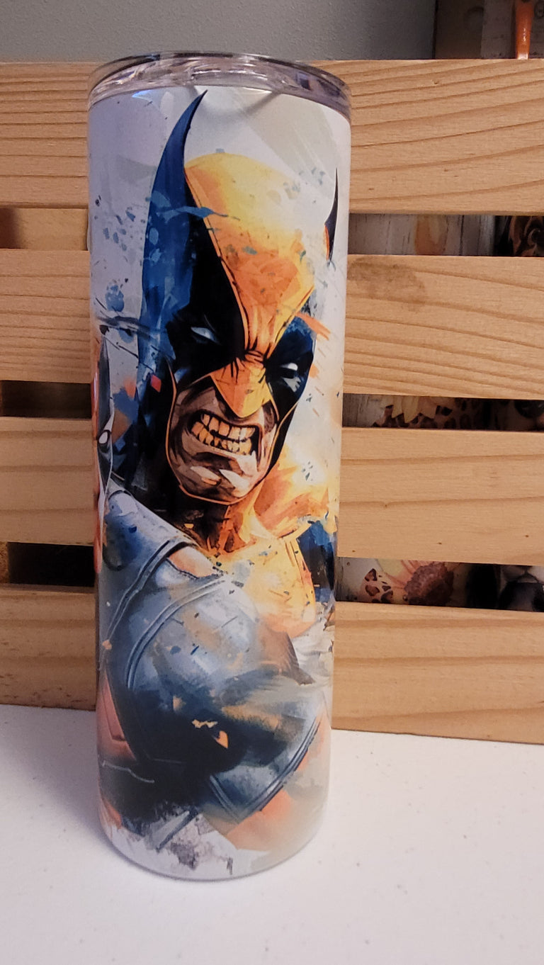 Deadpool & Wolverine...together finally! Here is a watercolor image of the pair. This 20 oz tumbler from Makerflo is made of a stainless steel double-wall construction and is vacuum insulated, with a clear sliding classic lid and a clear straw, and is BPA free. It is capable of retaining cold temperatures for 24+ hours or warm temperatures for up to 8 hours.