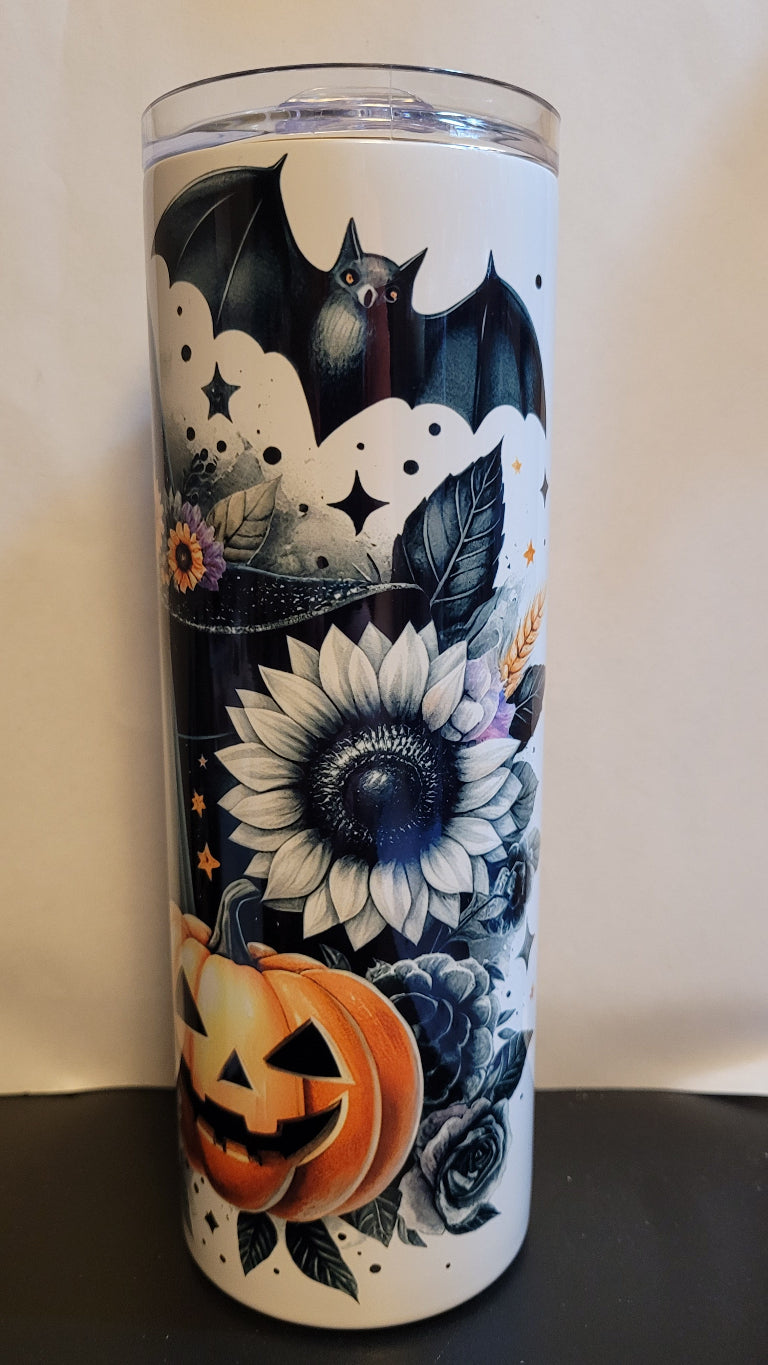 Not all ghosts are scary. Take this adorable Sunflower Ghost wearing a witch hat with a bat overhead and a carved pumpkin in the foreground. This is a stainless tumbler that mirrors our glass can tumbler version. This 20 oz Tumbler from Makerflo is double walled from stainless with great insulating properties.