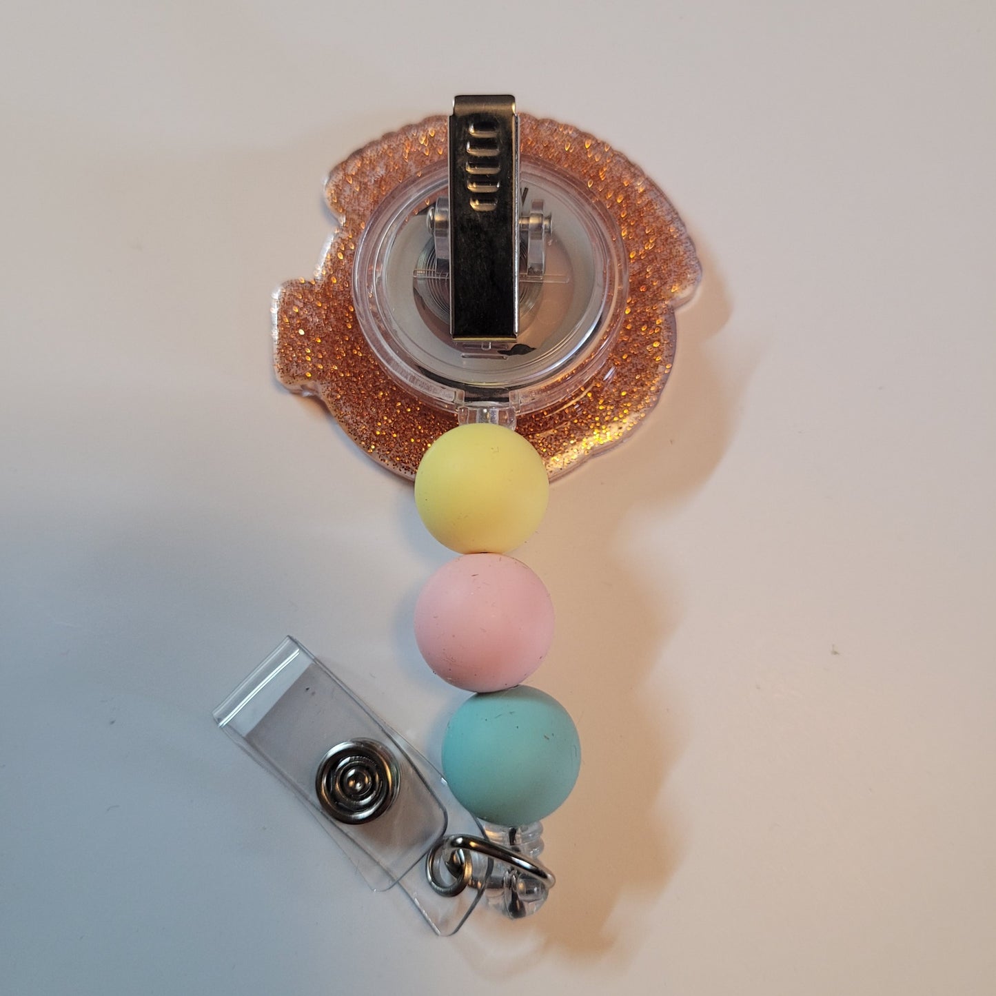 Badge holder with colorful beads and a glittery top on a white background