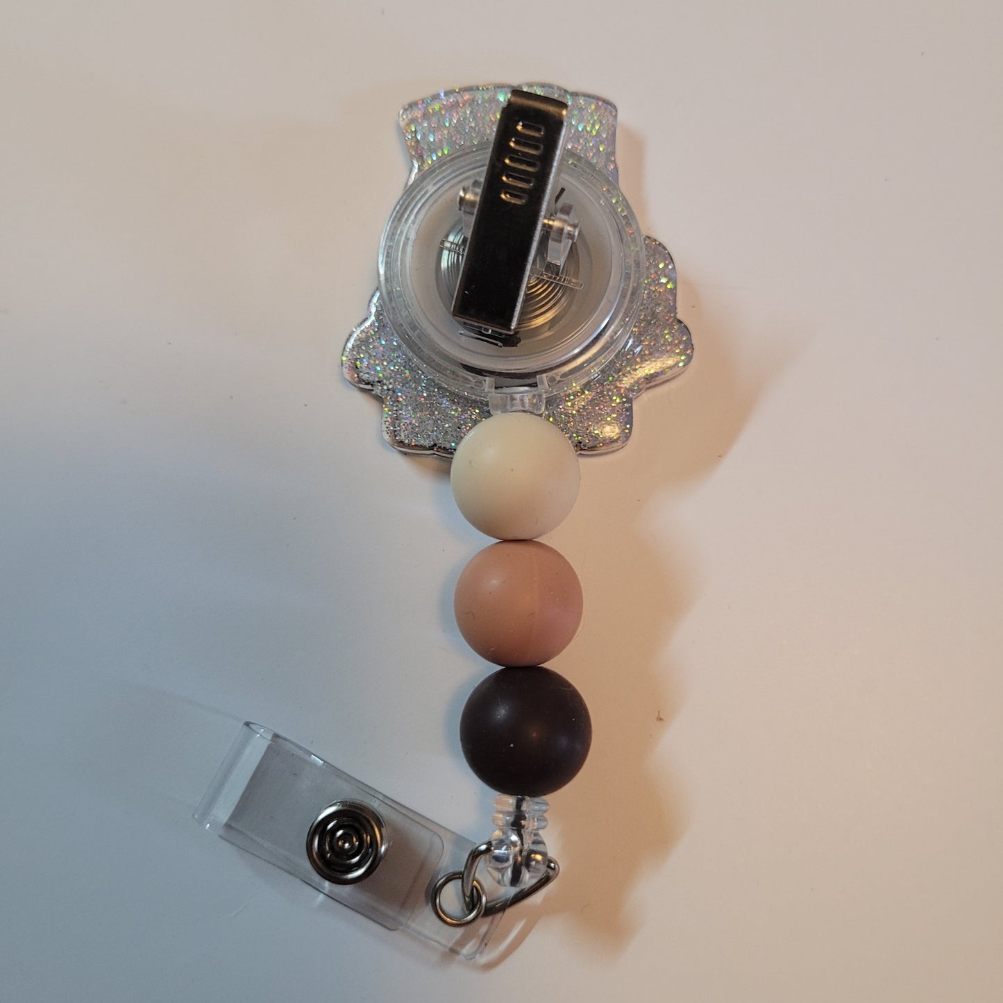 Badge holder with colorful beads and a decorative top on a white background