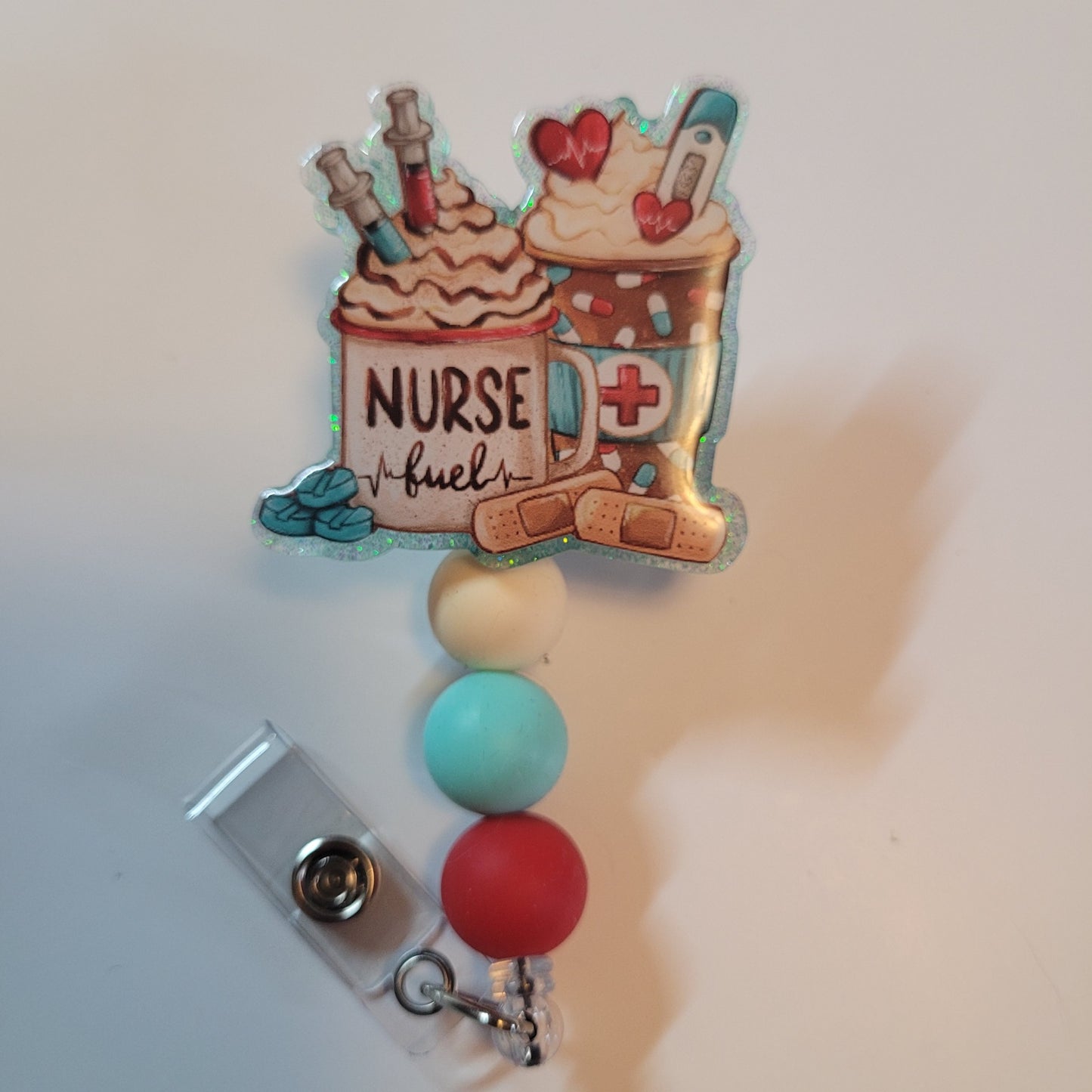 Colorful badge holder with 'Nurse Fuel' design on a white background