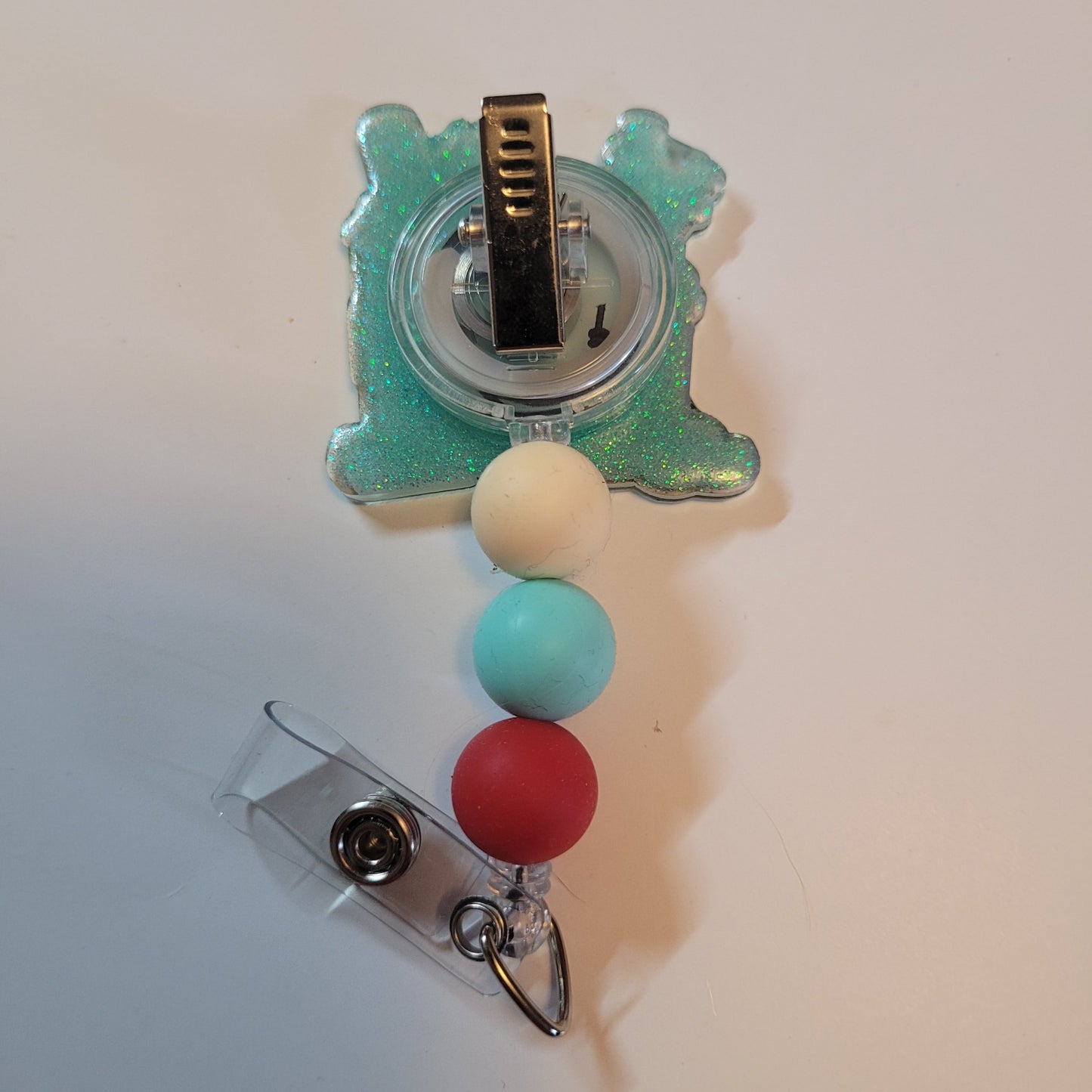 Badge holder with colorful beads and a clip on a white background