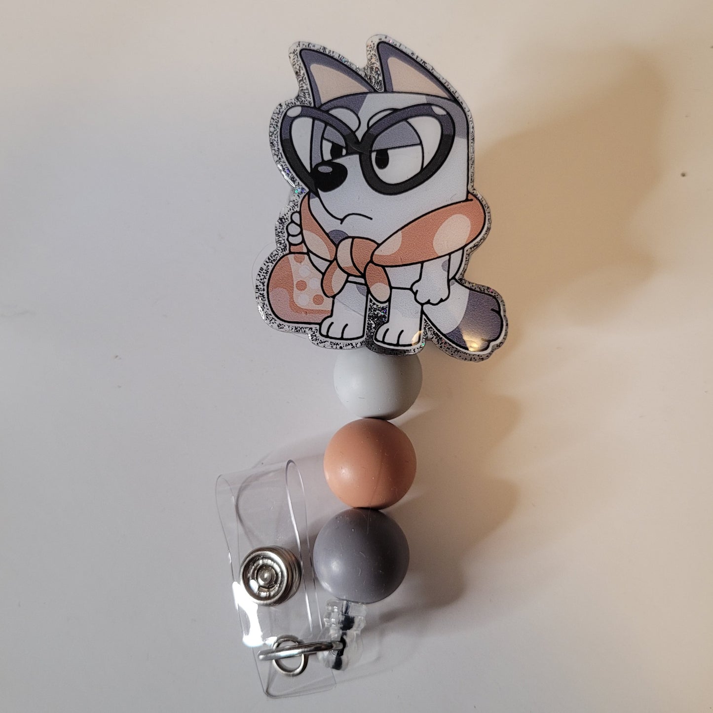 Badge holder with cartoon character design on a plain background