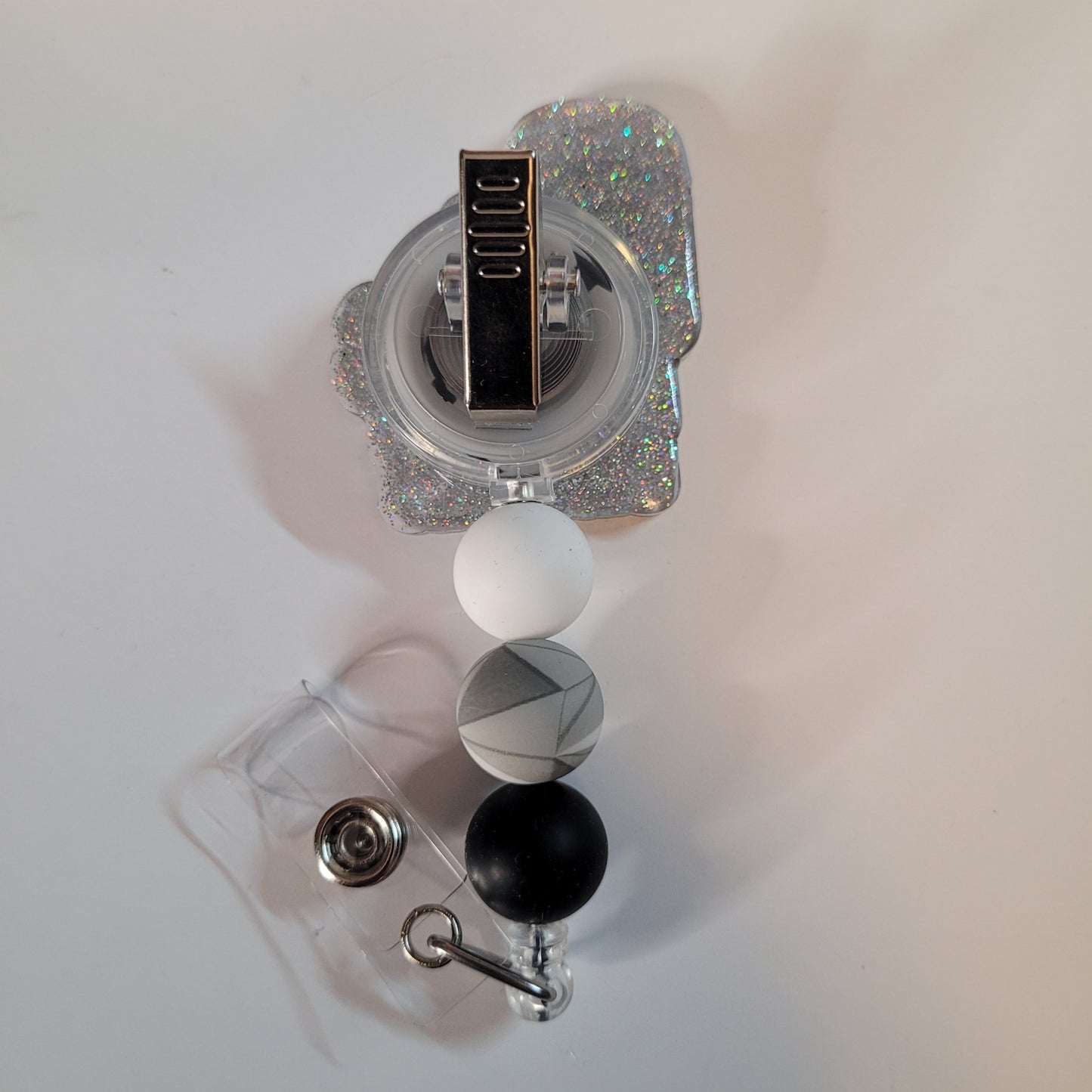 Retractable badge holder with colorful beads on a white background