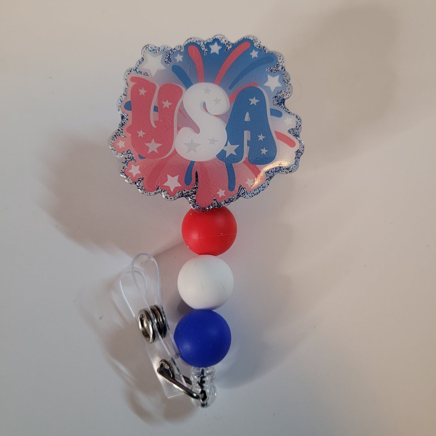 Retractable badge holder with 'USA' design on a plain background