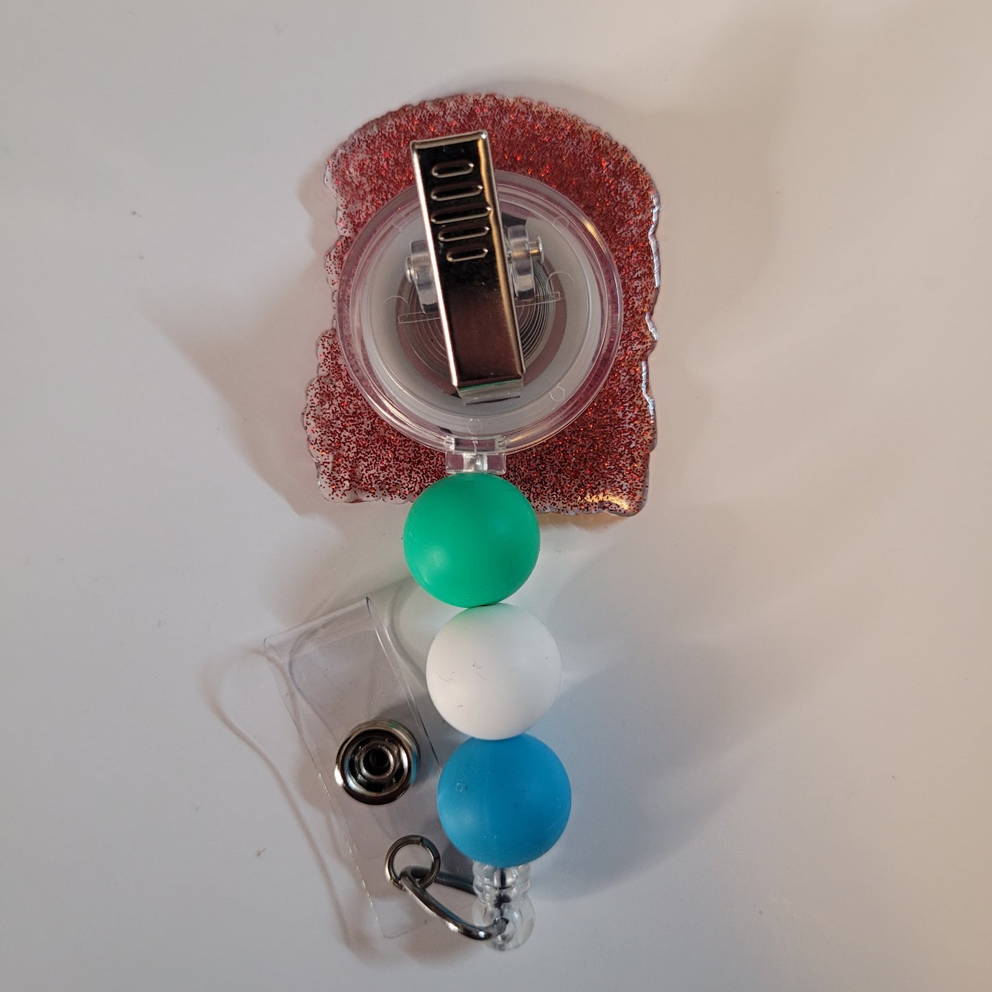 Retractable badge holder with colorful beads on a white background