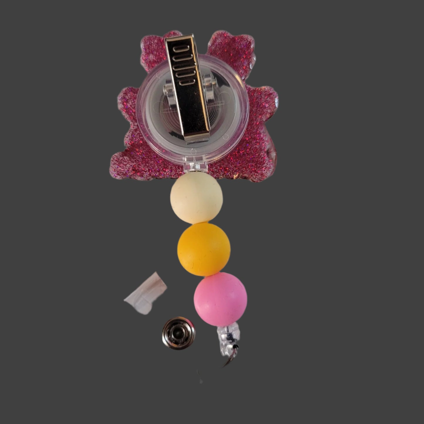 Badge holder with colorful beads and a pink flower-shaped clip on a white background