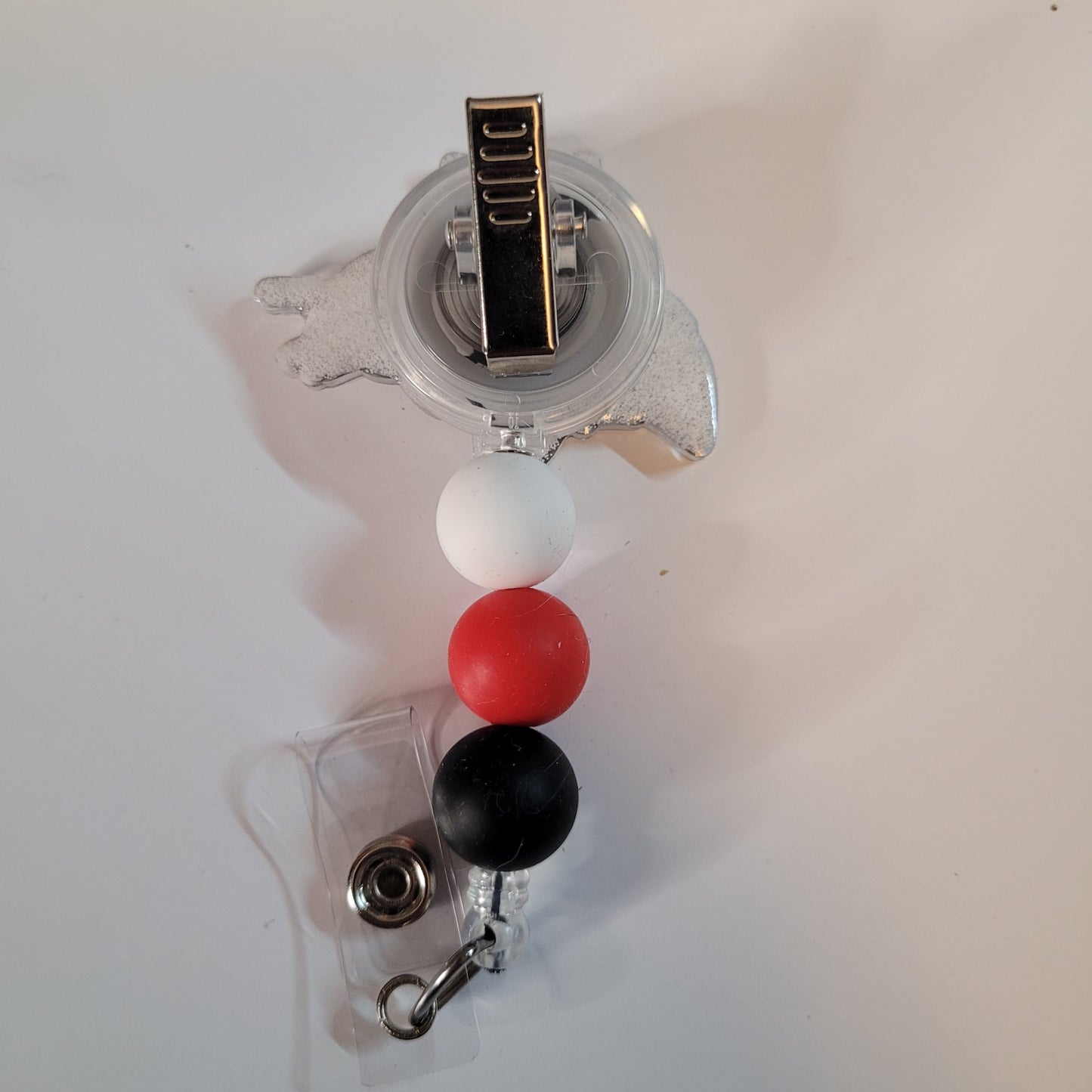 Retractable badge holder with colorful beads on a white background