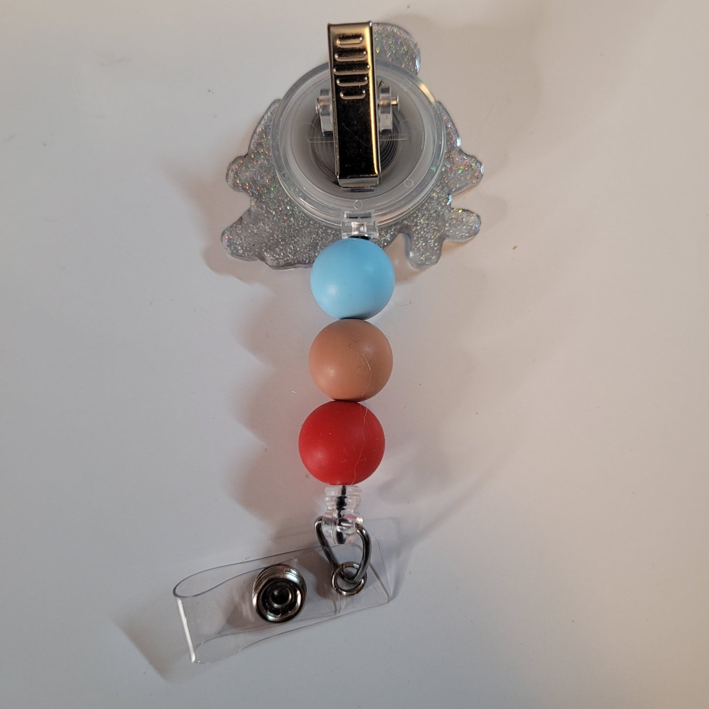 Colorful beaded badge holder with a clear clip on a white background