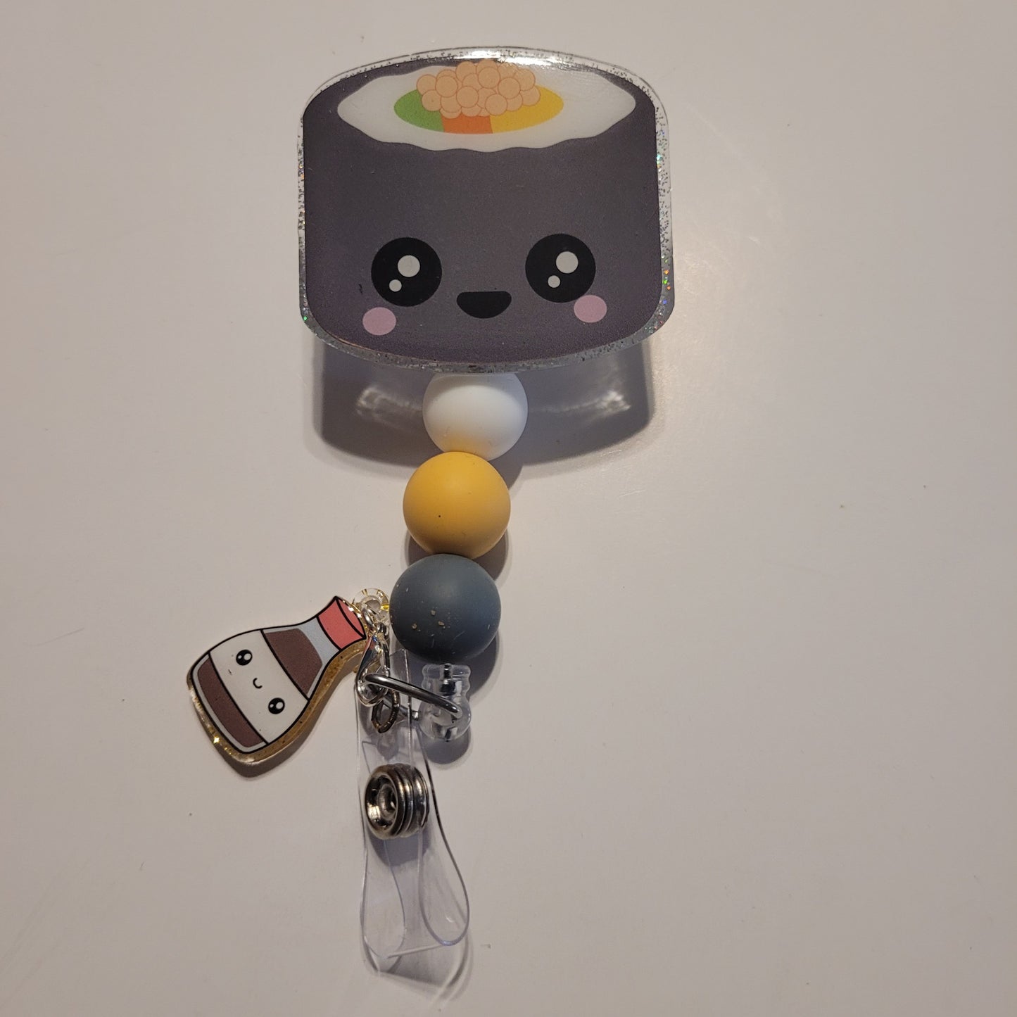 Retractable badge holder with a cute sushi design on a white background