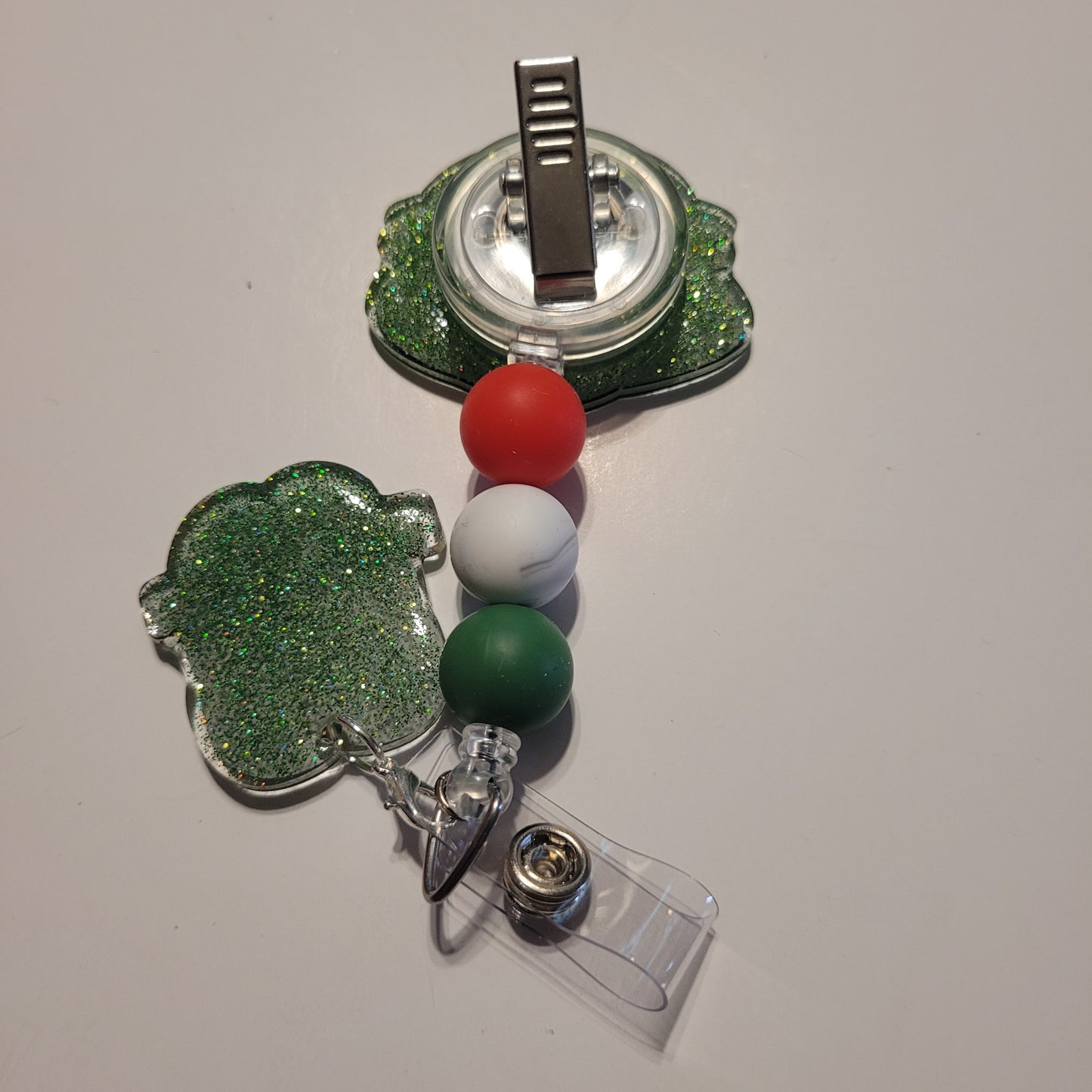 Retractable badge holder with colorful balls on a white background