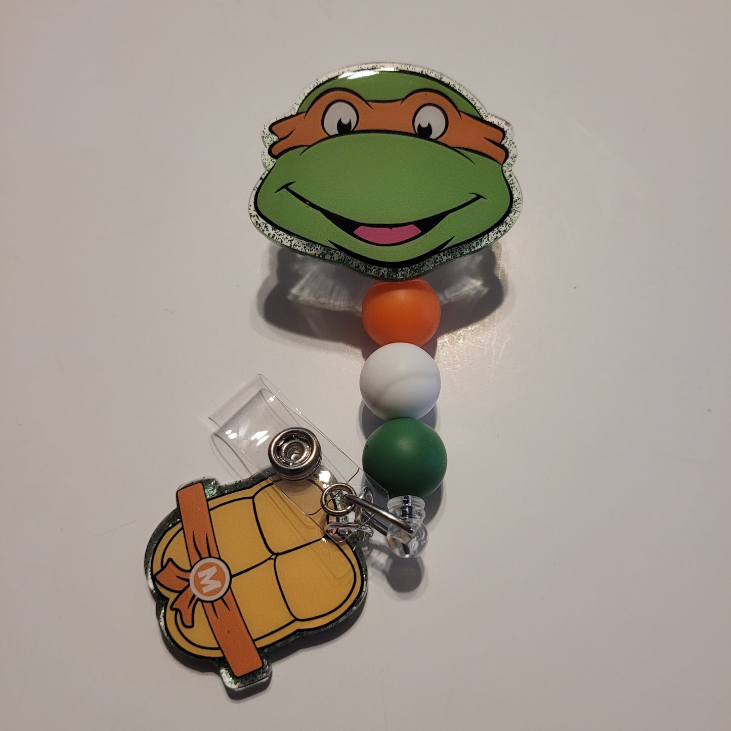 Retractable badge holder with cartoon turtle design on a white background