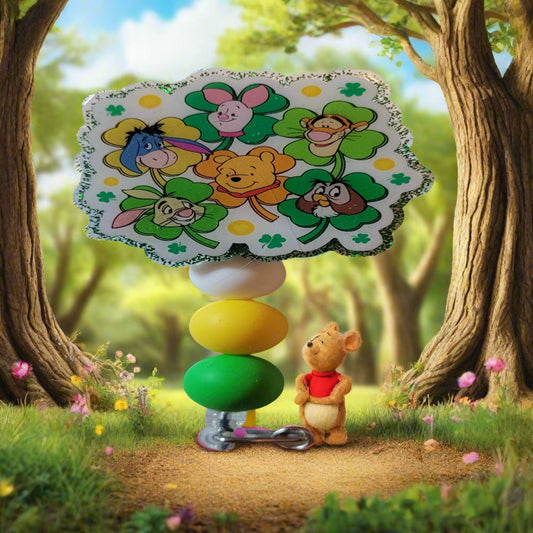 Here we have a fun 100 Acre Friends Badge Reel featuring all your favorite character's on lucky 4 leaf clovers. A green glitter back and 3 matching silicone beads finish the look.