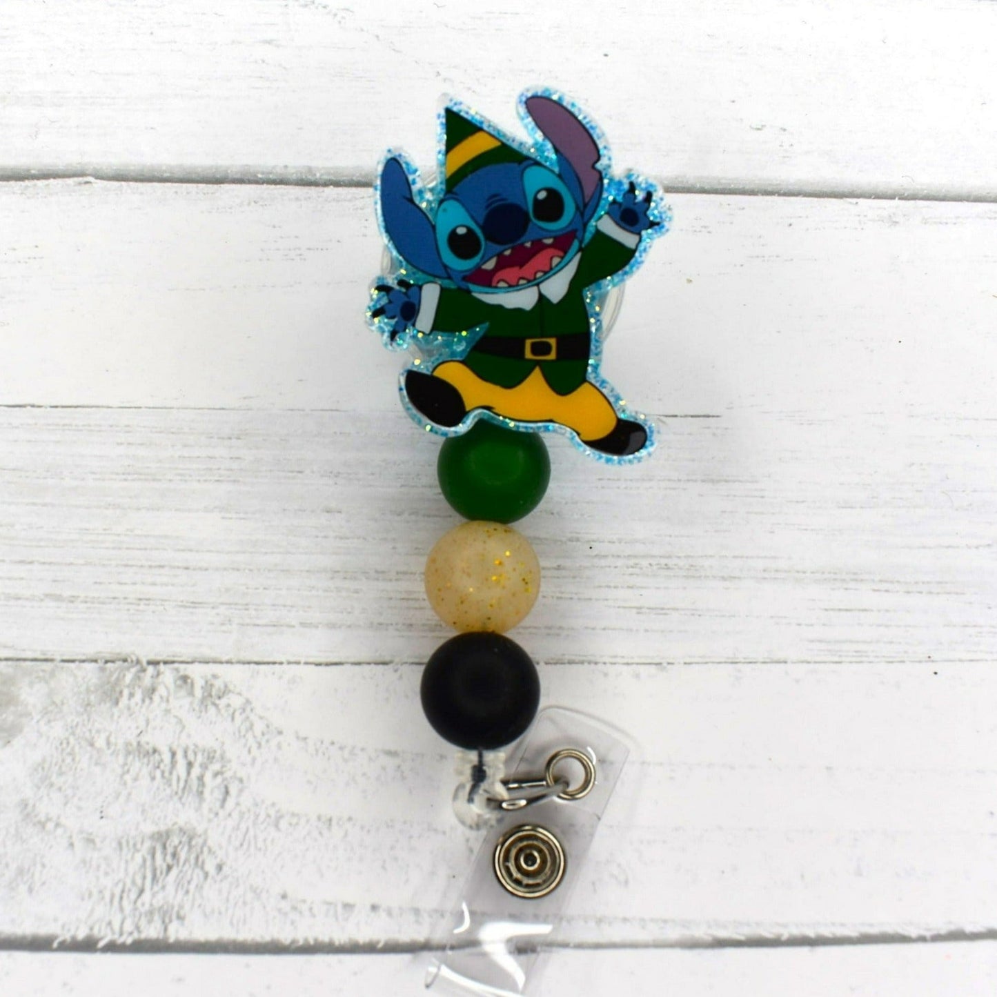 This badge reel features Experiment 626 enjoying Christmas. 4 different versions available. All badge reels feature a glitter base and color coordinated beads.