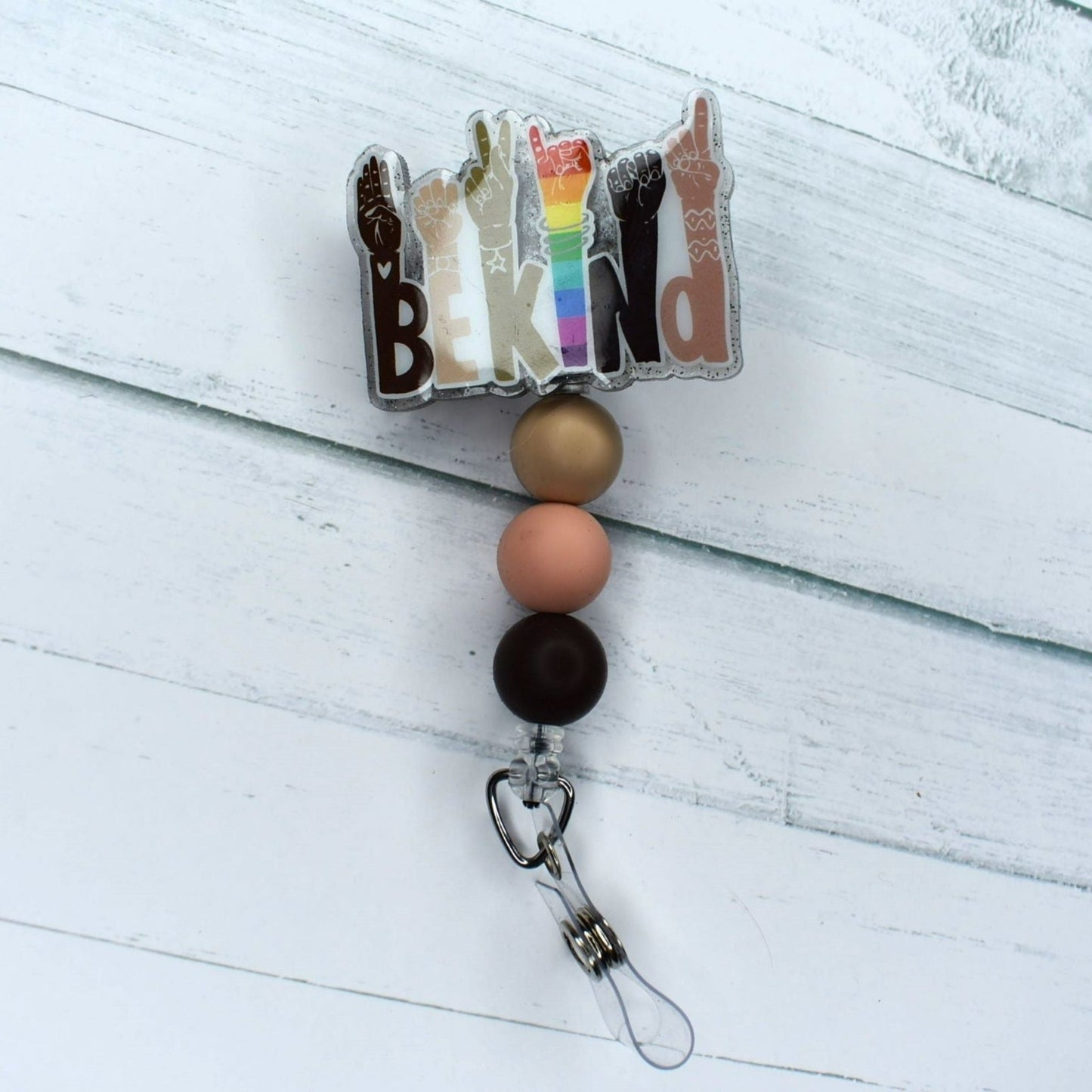 This acrylic Be Kind badge reel promotes kindness to others and is complemented with three coordinating silicone beads.