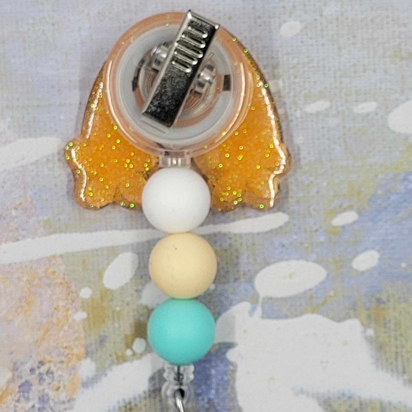 Introducing the new CNA Badge Reel, part of our latest collection of Medical Badge Reels available now. Featuring CNA in blue lettering in front of a rainbow with white daisy's and a yellow gold glitter base adorned with coordinating beads, this Badge Reel is sure to catch the eye.