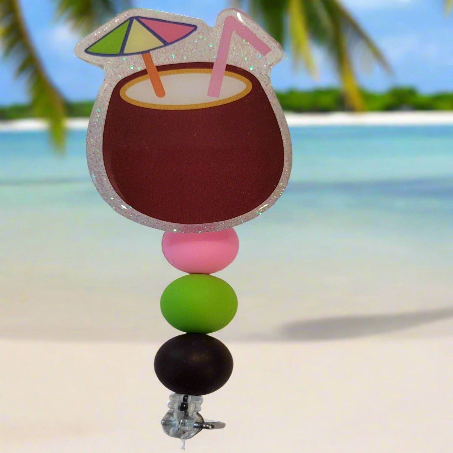 Enjoy this tasty Caribbean Cocktail Badge Reel that any rum lover would be happy to have. Sporting a drink in a coconut shell with umbrella & straw, glitter back and 3 color coordinated silicone beads to finish the look. Last Call! 
