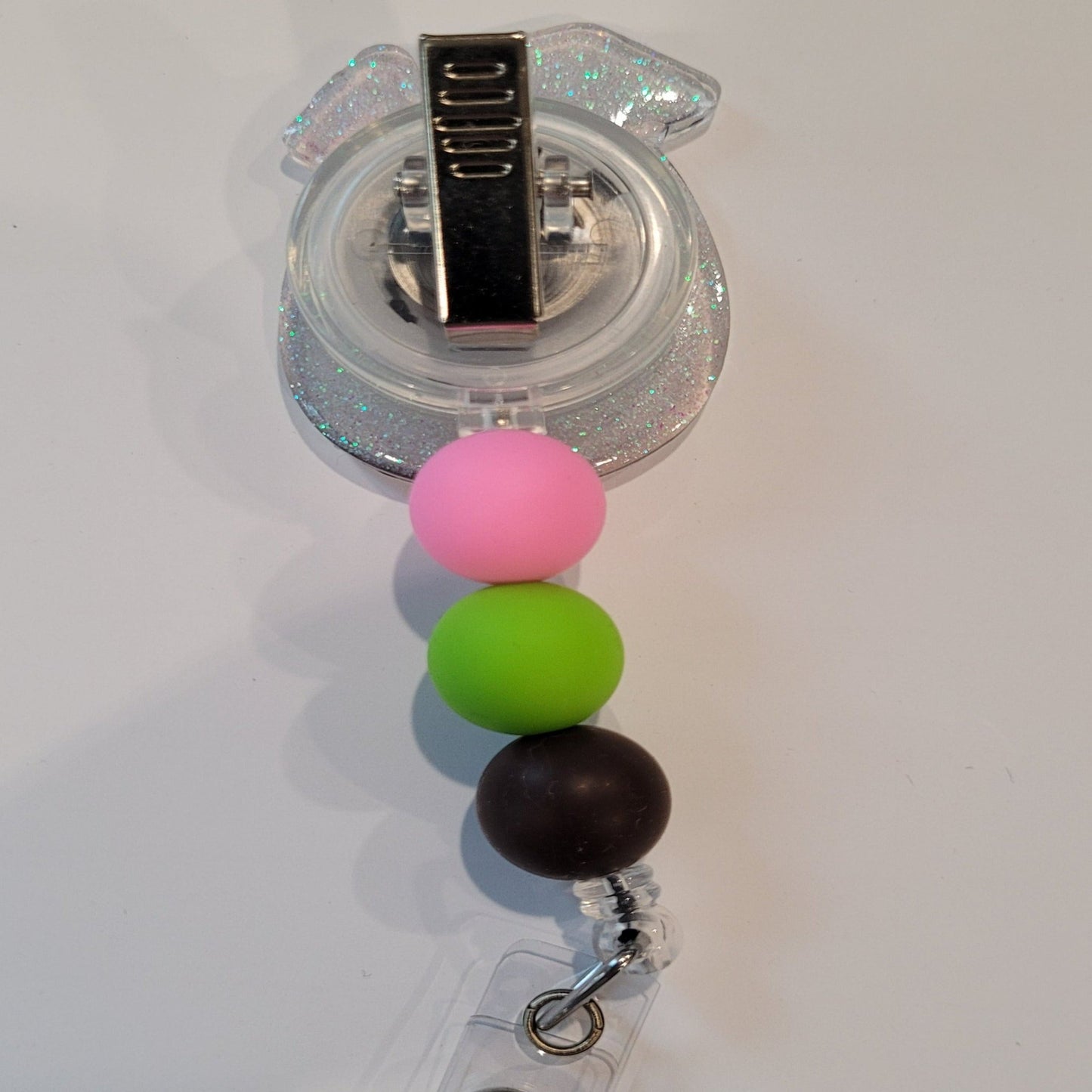 Enjoy this tasty Caribbean Cocktail Badge Reel that any rum lover would be happy to have. Sporting a drink in a coconut shell with umbrella & straw, glitter back and 3 color coordinated silicone beads to finish the look. Last Call! 