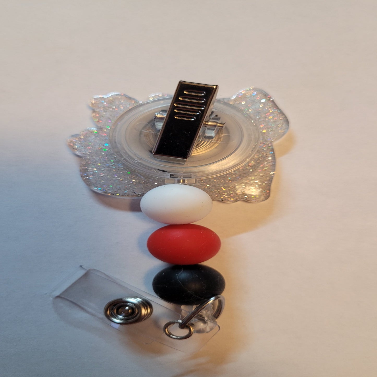 Introducing to our collection of Medical Badge Reels available now, the Cat Scan. You know, a Computed Tomography image...uhm or a scan of a cat? This playful badge reel shows a black cat with a cat scan of his skeleton. Features a clear glitter back and 3 matching silicone beads to finish the look.