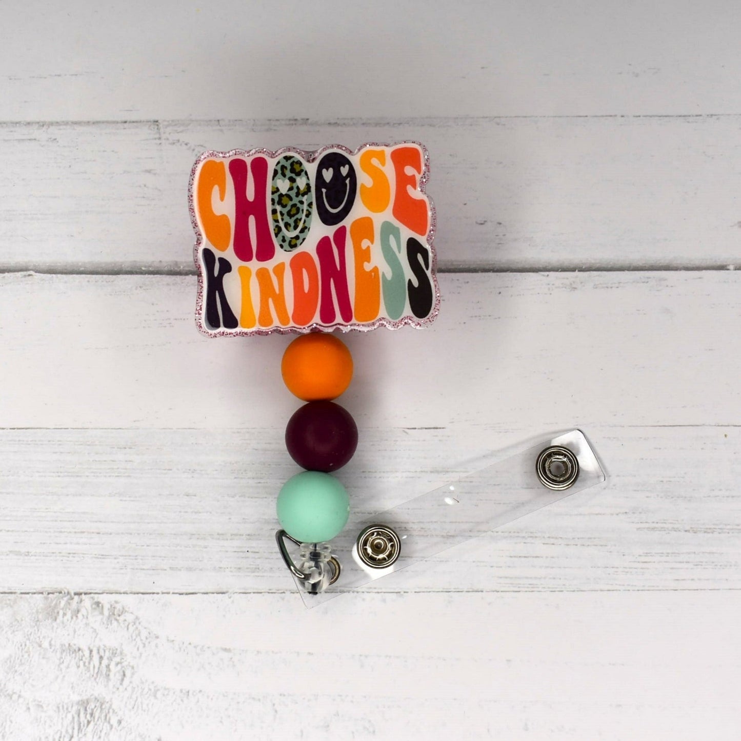“How do we change the world? One random act of kindness at a time.” — Morgan Freeman Wise words we can all take to heart. Simply put, choose kindness. Badge reel has a glitter base with 3 color coordinated silicone beads. One of my quotes I remembered from my childhood..."Be Kind and Rewind"....Blockbuster