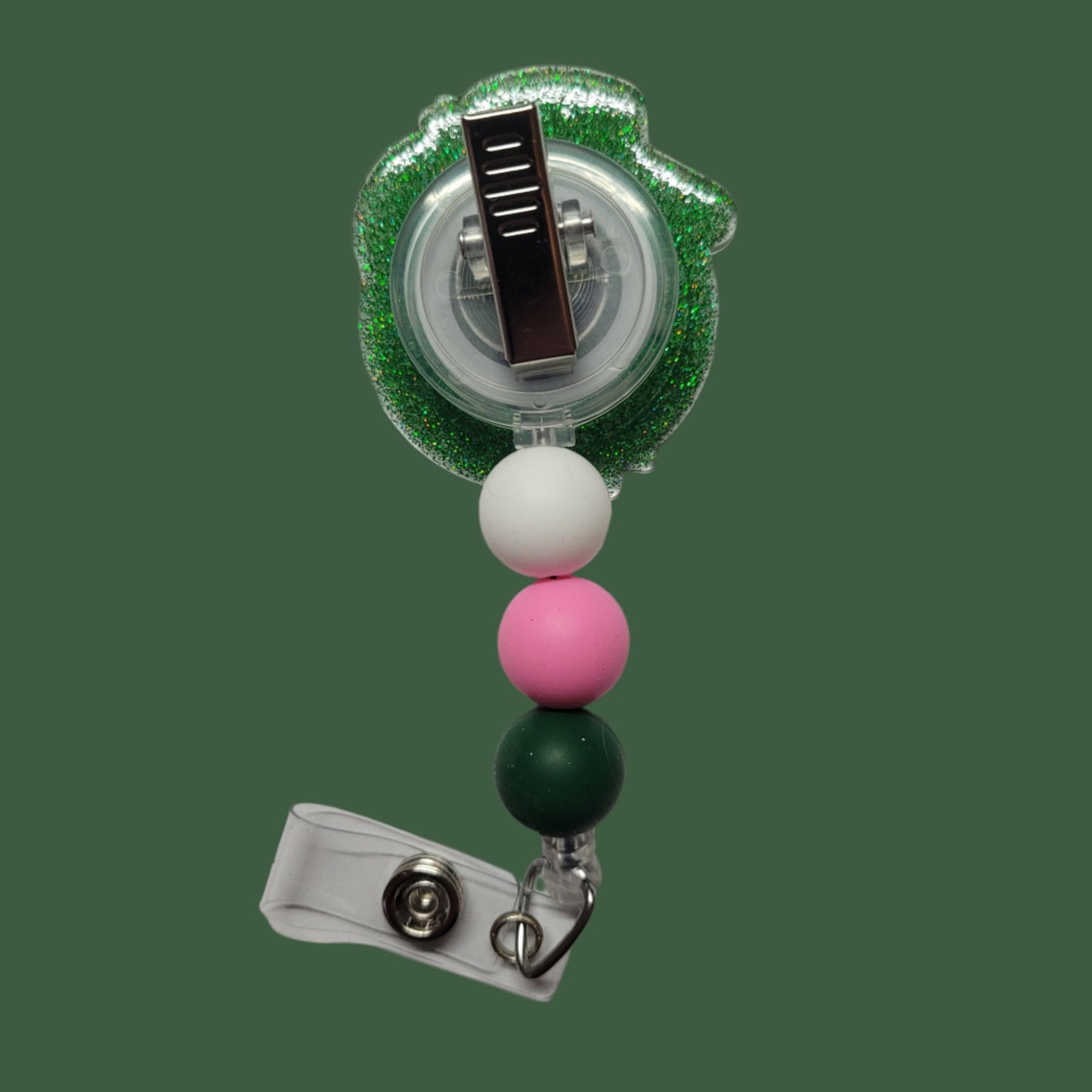Every cowgirl needs a hat. This acrylic badge reel showcases a classic cowgirl hat in the color pink atop a green disco ball all ready for a night of dancing at the local honkey tonk. A green glitter back and 3 silicone beads finish the look.