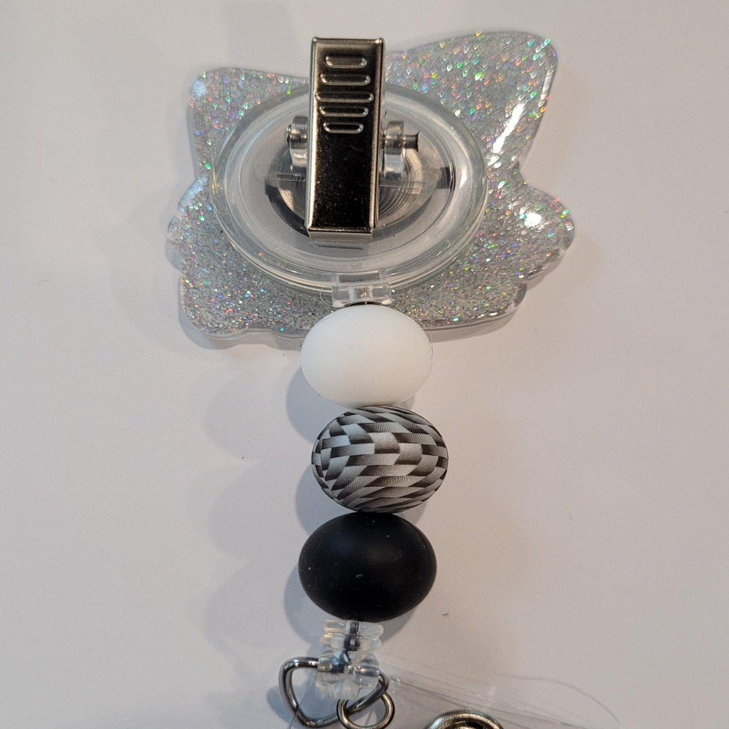 Introducing the new Gnome X-Ray Tech Badge Reel, part of our latest collection of Medical Badge Reels available now. Featuring a cute Gnome examining an X-Ray dressed in shades of gray and a silver glitter base adorned with silver black & white 3d visual bead and s more color coordinating beads, this Badge Reel is sure to catch the eye.