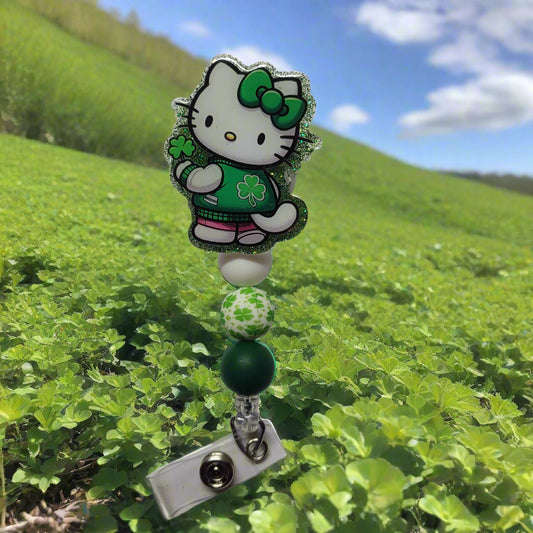 By popular demand we bring you a new series of Kitty Badge Reels. Here is our Lucky Kitty sporting a green clover adorned jacket and green ribbon in her hair. Green glitter on the back and 3 silicone beads, 1 of which is a clover focal bead, finish the look.