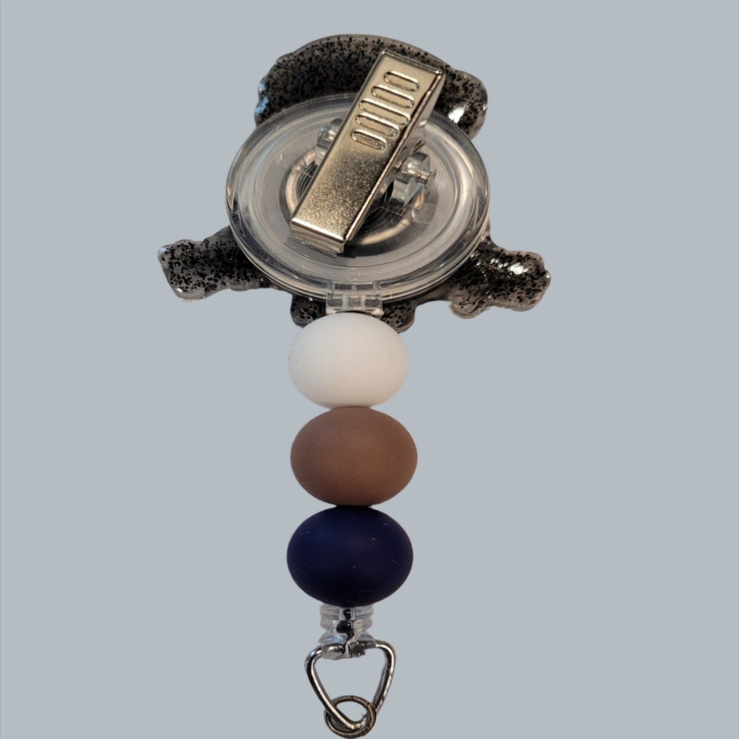 There is no Doubt Help Is On The Way Dear with this acrylic badge reel. Featuring a black glitter back and 3 color-coordinated silicone beads add the perfect finishing touch to this out-of-this-world badge reel.