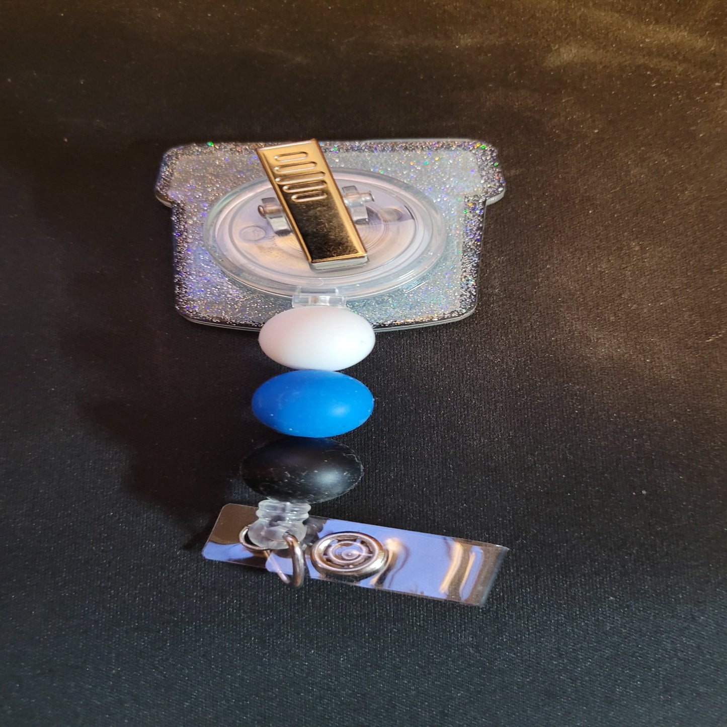 Part of our latest collection of Medical Badge Reels available now, we will need this filled for you bank deposit.... Uhm... Just Keep Swimming. Featuring a collection cup and a light blue glitter base adorned with coordinating beads, this Badge Reel is sure to catch....well we will leave that alone.