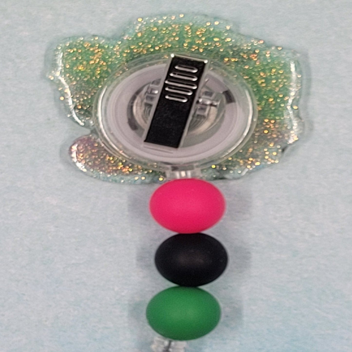 Love can be a Prickly thing, even so with a cactus! This cool cactus is wearing heart shaped glasses bordered with various hearts and overlays a green glitter background. Finished off with 3 silicone color coordinated beads. Great for the plant enthusiast.