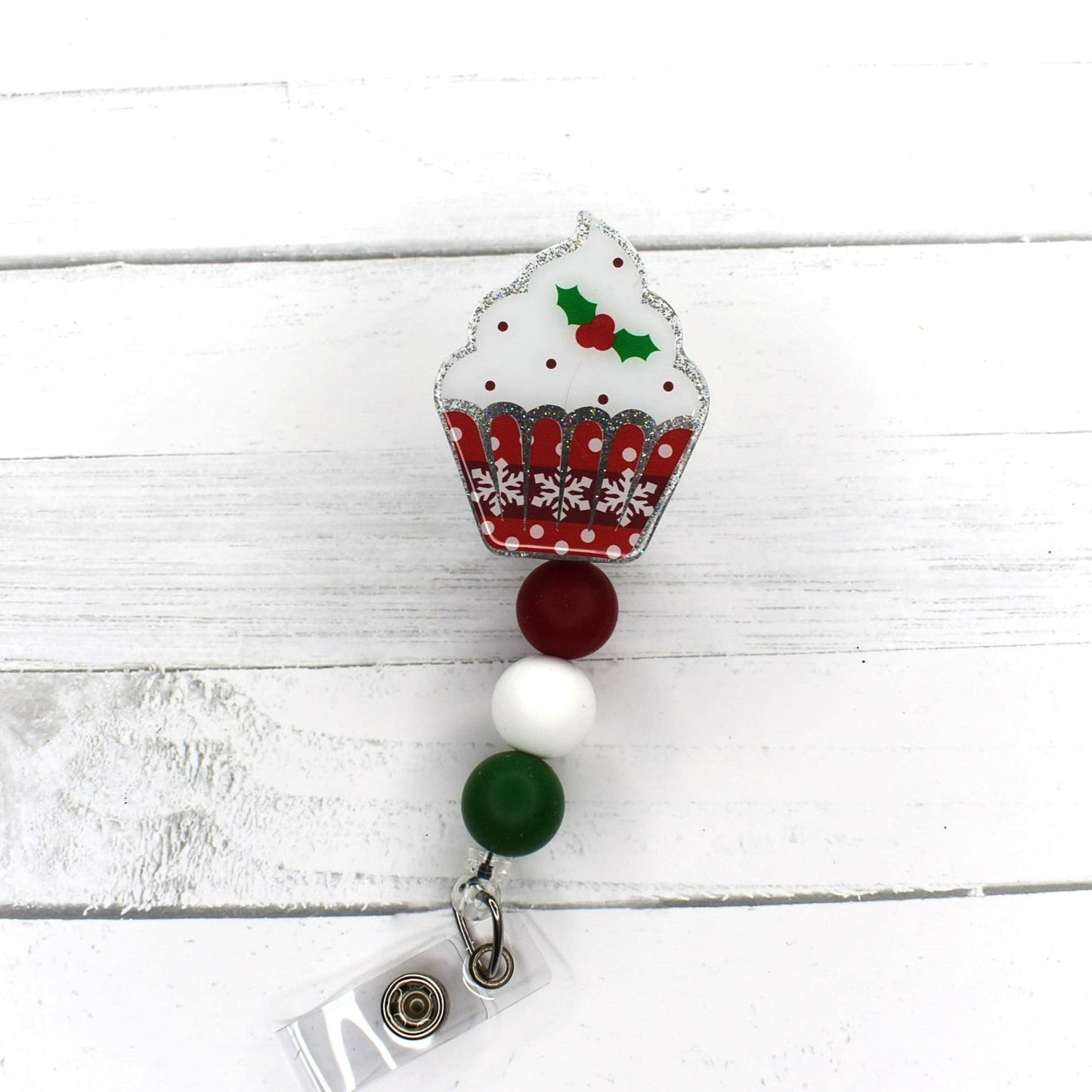 From our Limited Edition Christmas Cupcake Series this is 1 of 5 in the set. It is the Mistletoe Cupcake featuring a glitter base and a cupcake decorated with a white frosting and a sprig of Mistletoe. A red White & Green Silicone bead finish the look. Like any great snack, when it's gone... it's gone!
