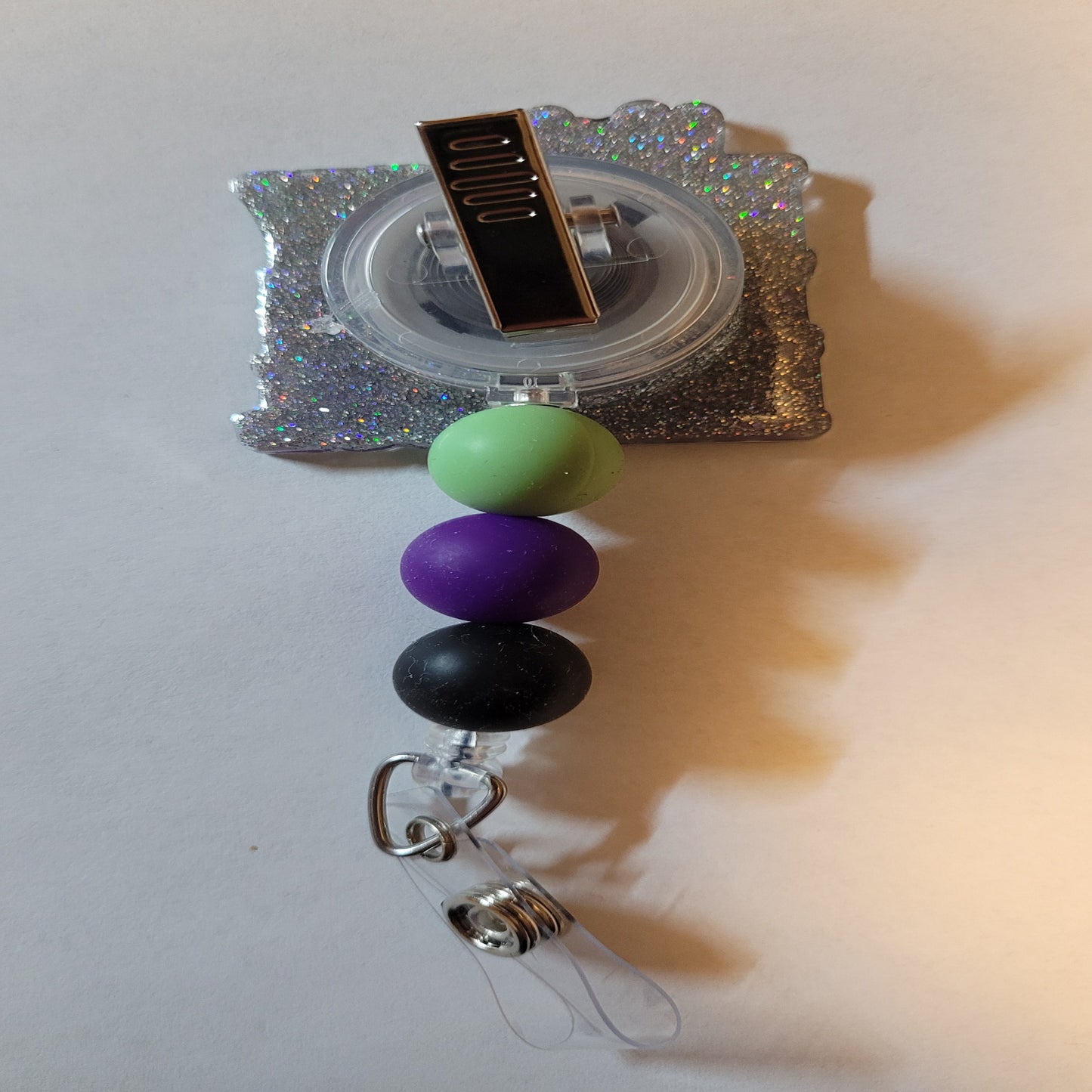 Not Bossy Just Aggressively Bossy. And if you don't like it too bad. This badge reel with attitude tells it like it is. It is finished with a clear glitter base and three carefully chosen silicone beads.
