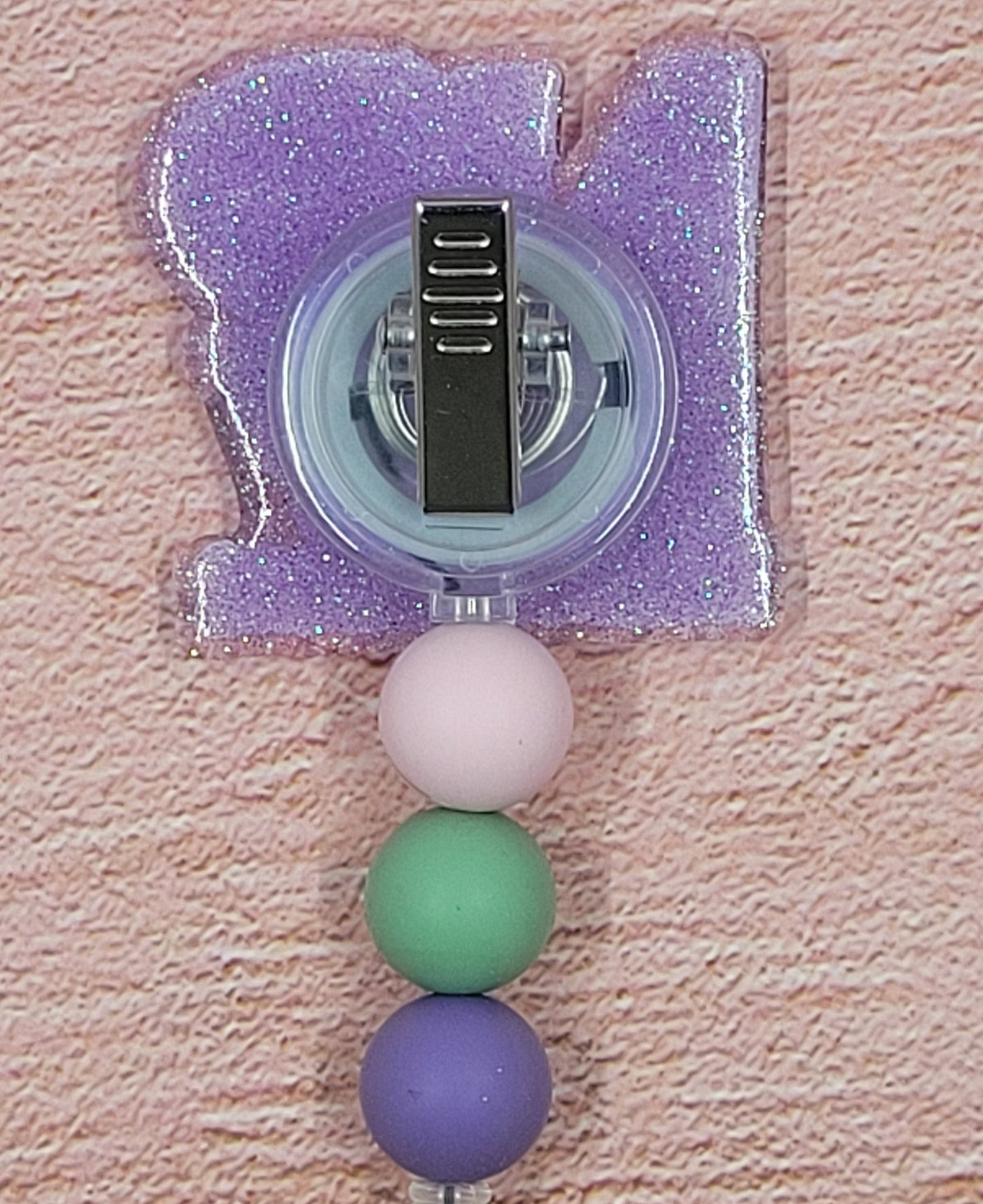 Introducing the new NP Badge Reel, part of our latest collection of Medical Badge Reels available now. Featuring Nurse Practitioner on the front and a purple glitter base adorned with coordinating beads, this Badge Reel is sure to catch the eye.