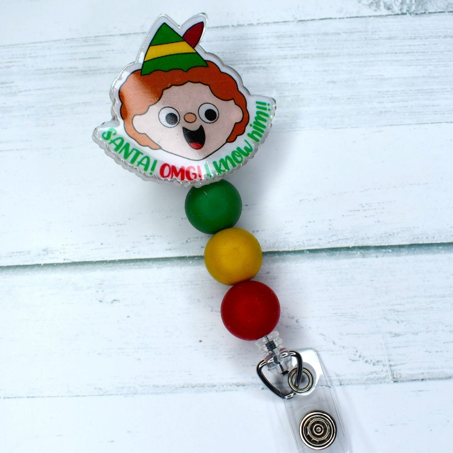 Buddy the Elf is here and OMG he knows Santa! This Christmas season acrylic badge reel features Buddy and the phrase... Santa OMG I Know Him. We offer this with 2 different sets of colored accent silicone beads.