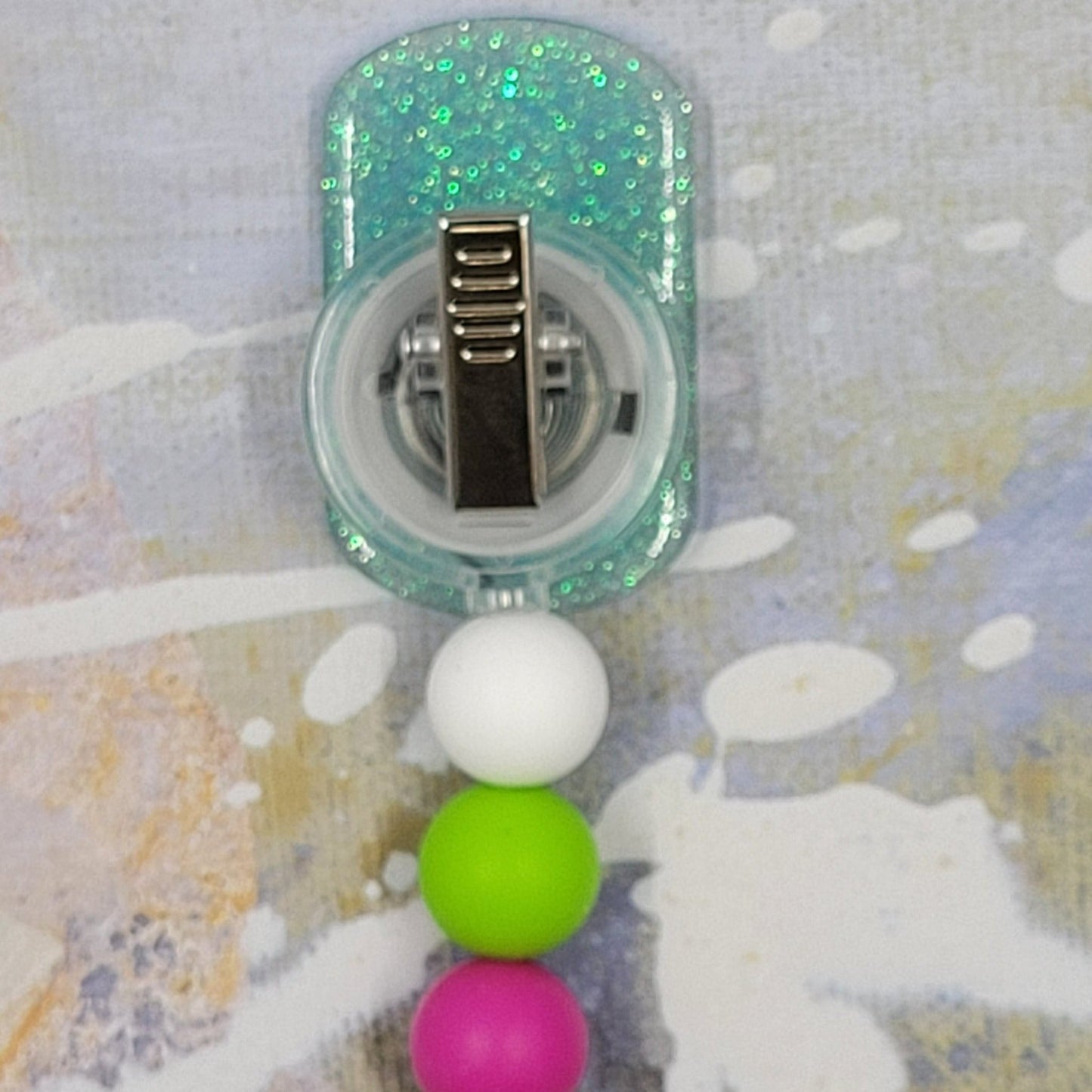 Part of our latest collection of Medical Badge Reels available now, we can write you a script for this Pretty Pill Badge Reel. Featuring a happy face with a pink bow and a light blue glitter base adorned with coordinating beads, this Badge Reel is sure to catch the eye.