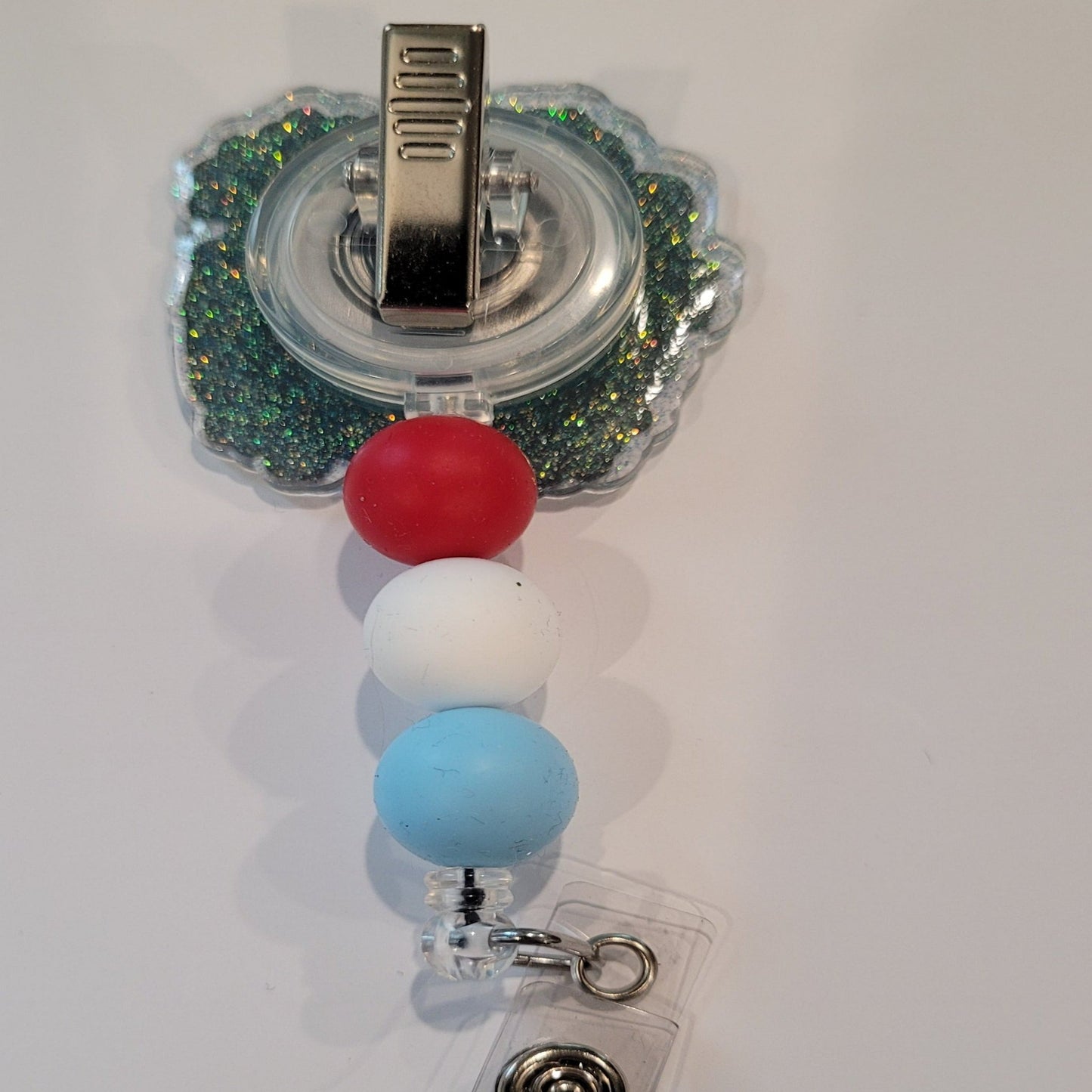 Experience the best 4th of July vibe with this Red White & Bluey Badge reel. Adding a touch of patriotism, this badge reel flaunts red, white, and blue silicone accent beads, perfect for watching the fireworks on our Nations Birthday..