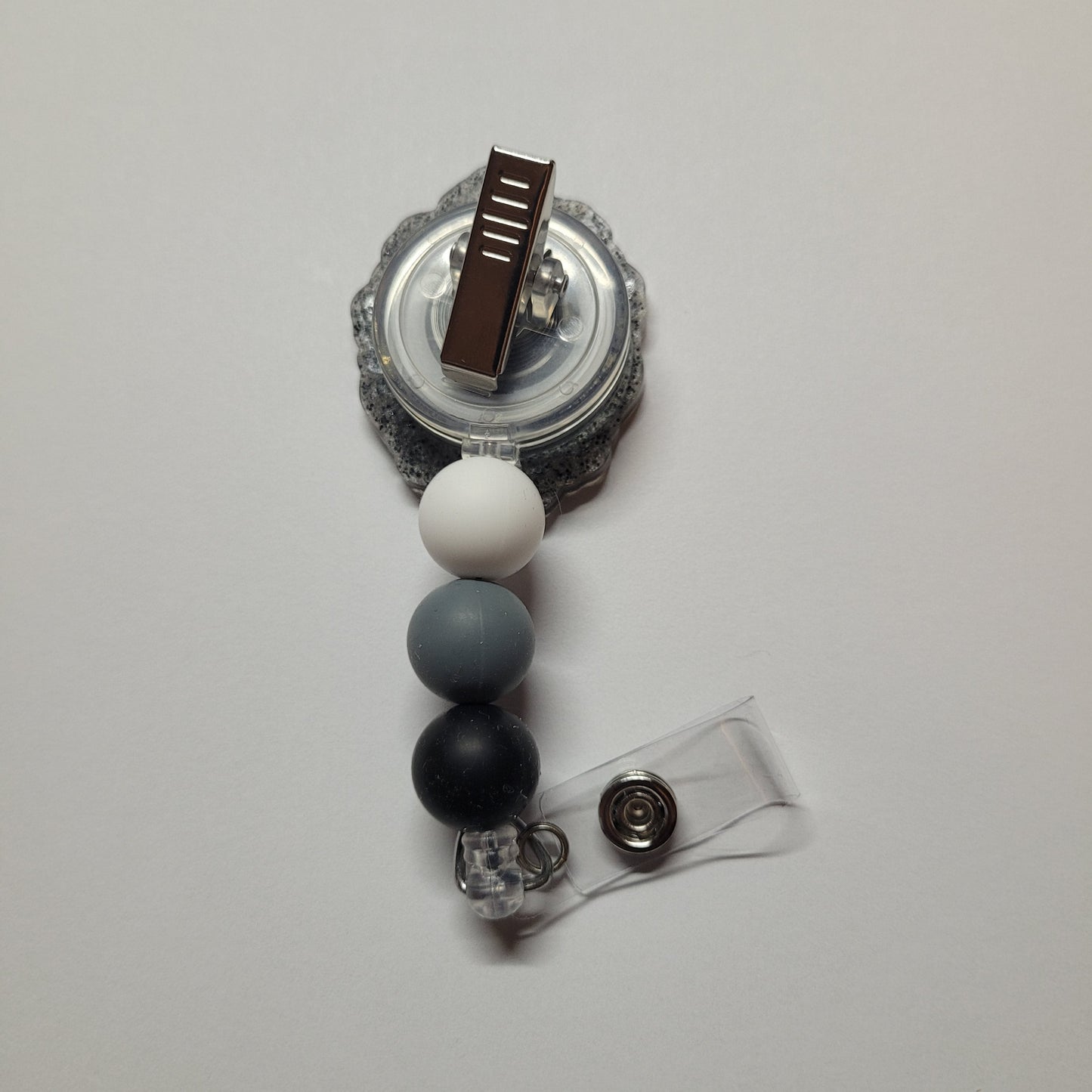 Feeling nostalgic. Here is our Silhouette badge reel depicting a late 1800s to early 1900s image of a lady with an ornate frame. Finished with 3 silicone beads.