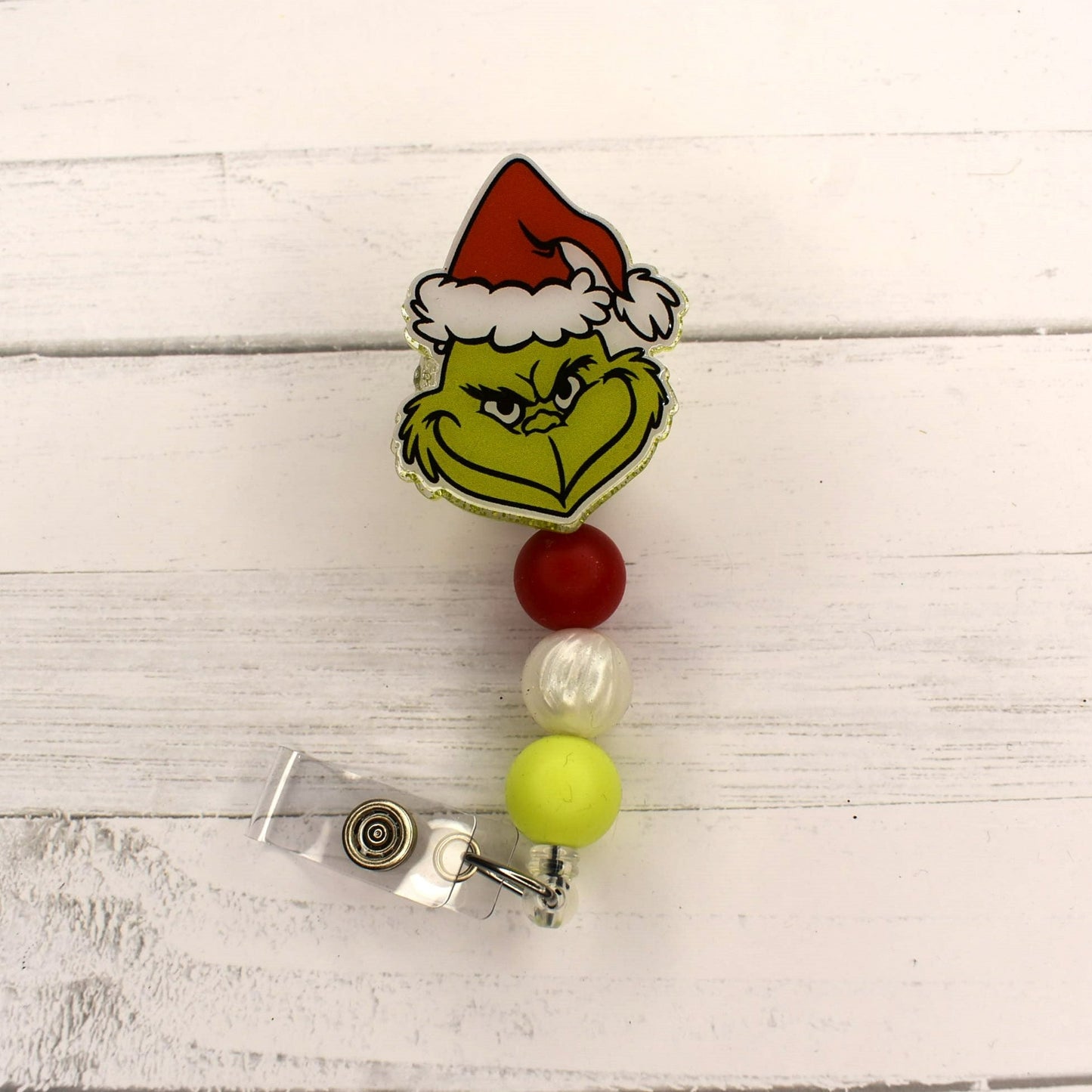 Holiday cheer always brings him near to take away Christmas. This badge reel is sure to put a smile on any grinch you might know. 3 color coordinating silicone beads finish the look.