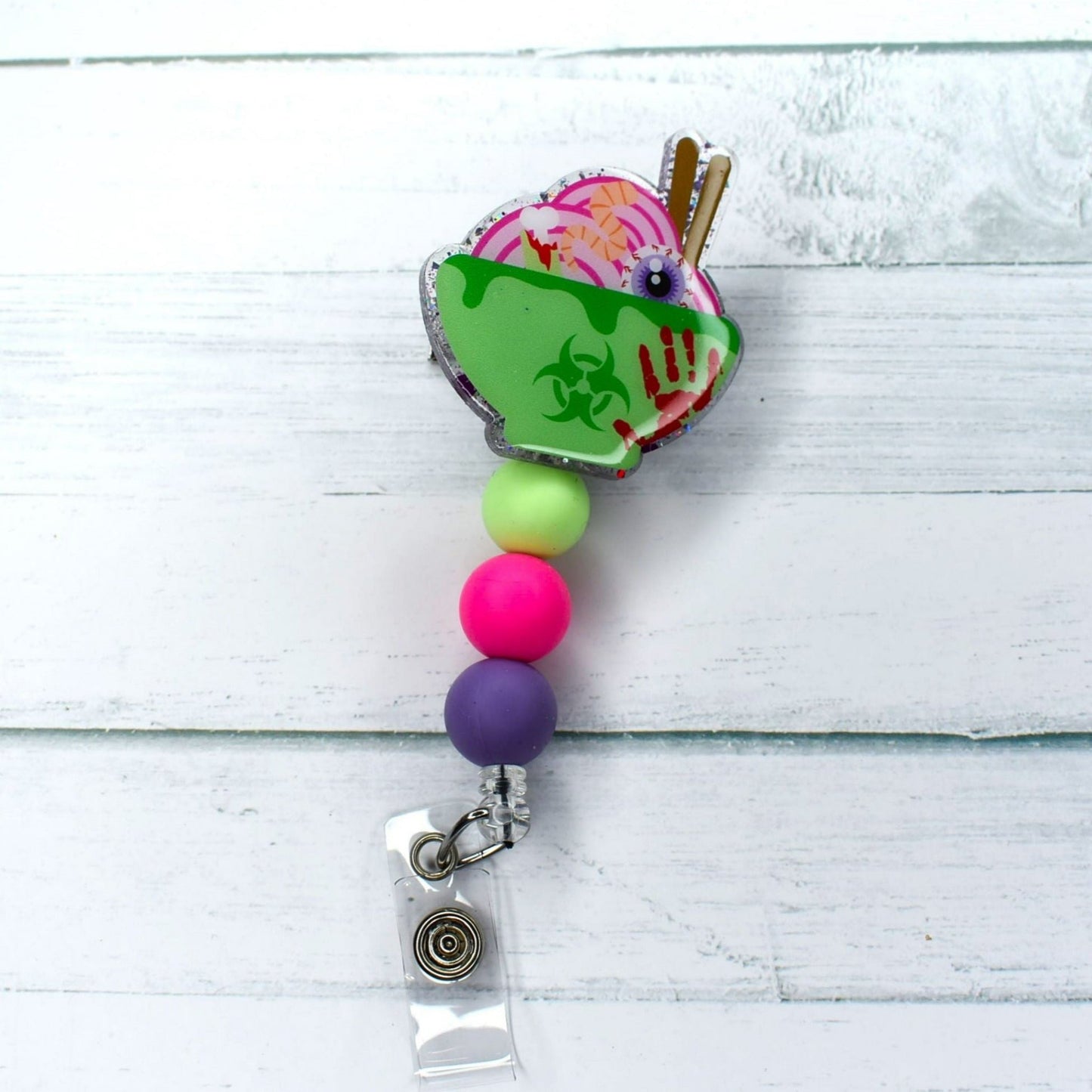 Tonight's special is Toxic Noodles! This acrylic badge reel features a green bowl full of toxic noodles. Green pink & a purple silicone bead finish this course. Leave room for dessert!