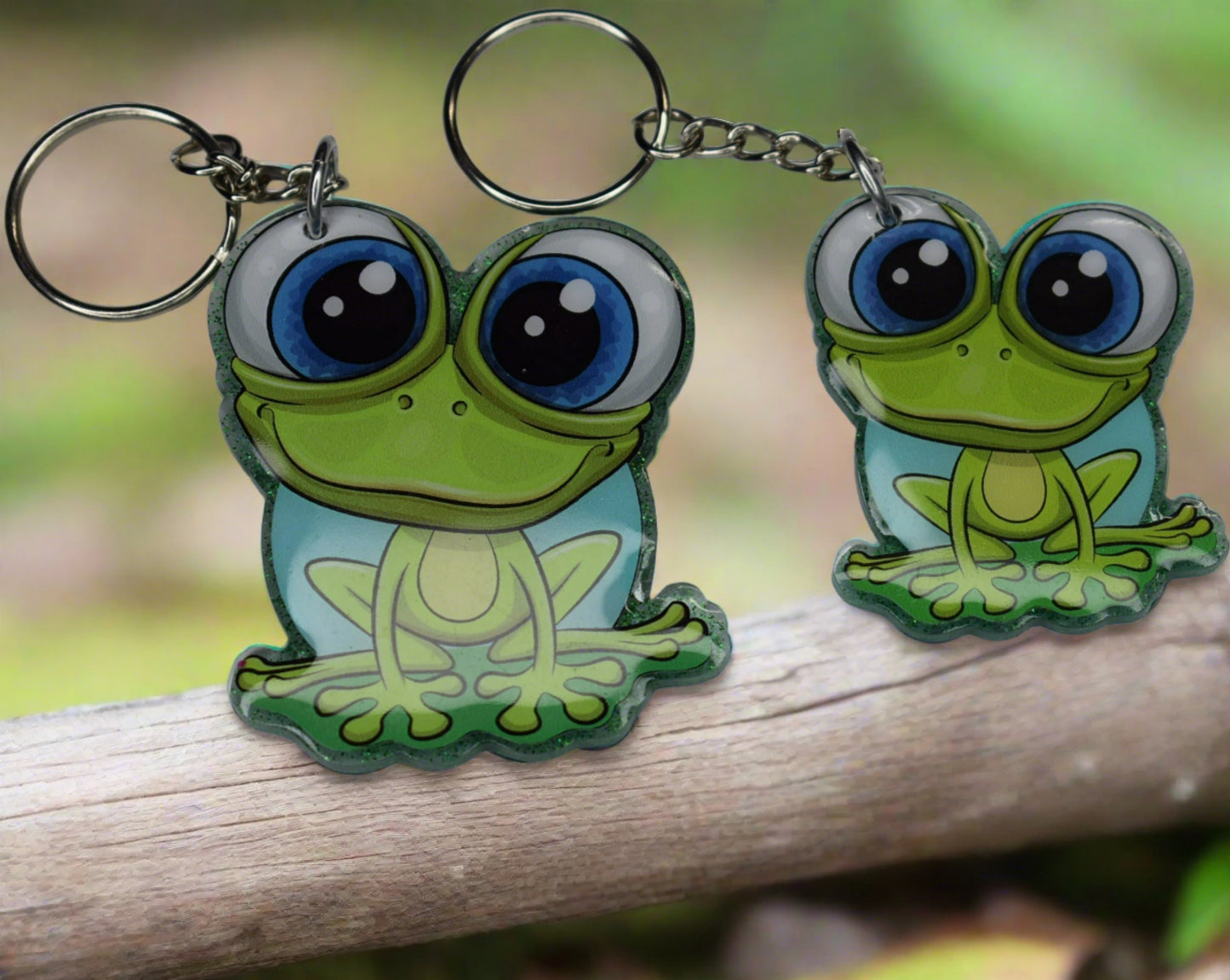 This Frog Keychain is hopping with happiness! Made from durable acrylic resin he comes with a green glitter background and a great happy smile. Available in 2 sizes. Small measures 1.5" x 2" and the large at 2" x 2.5".
