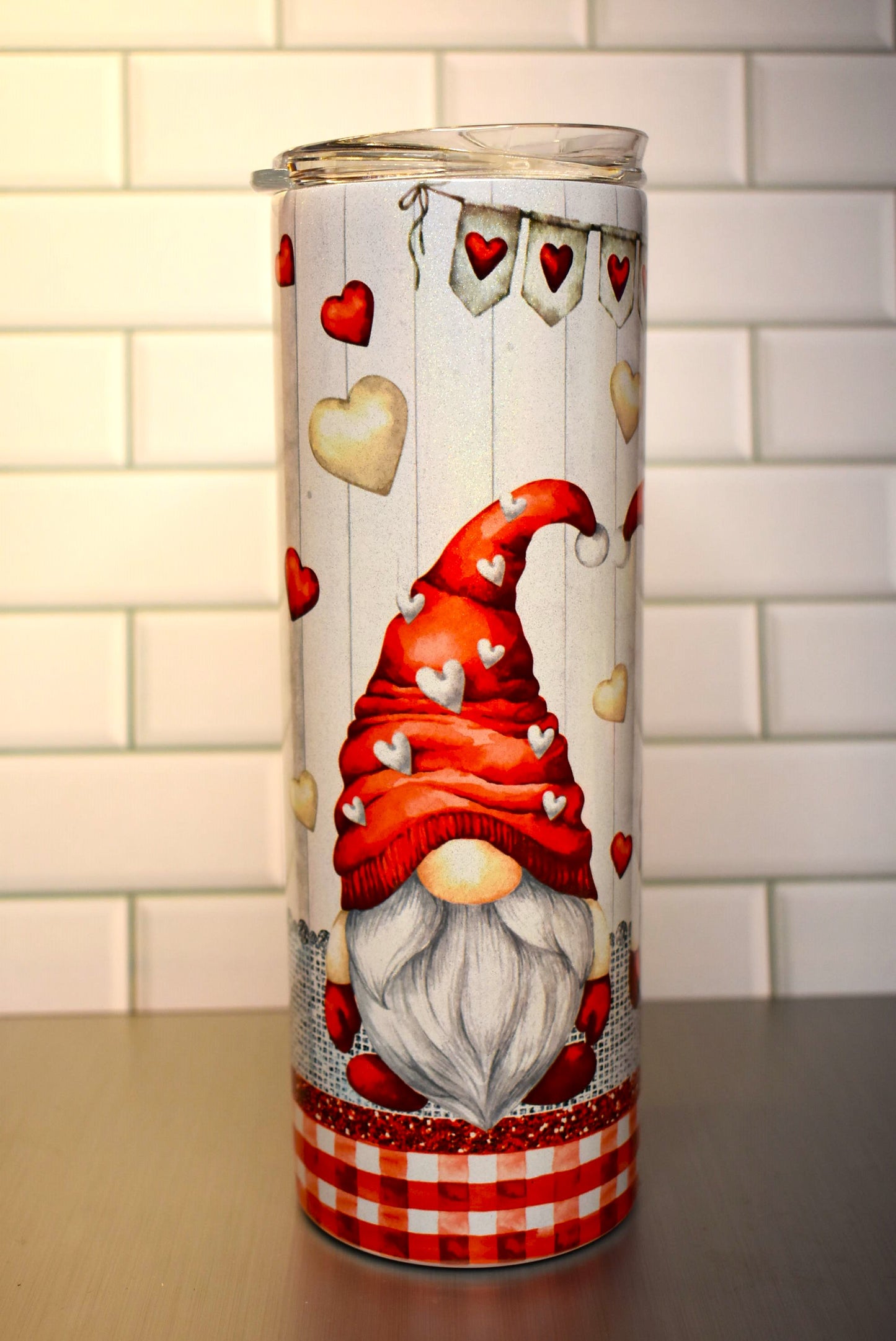 This 20 oz Makerflo Stainless Steel tumbler features a Gnome Love Couple design This love couple features red & white hearts floating all around with a heart banner circling the tumblers top.