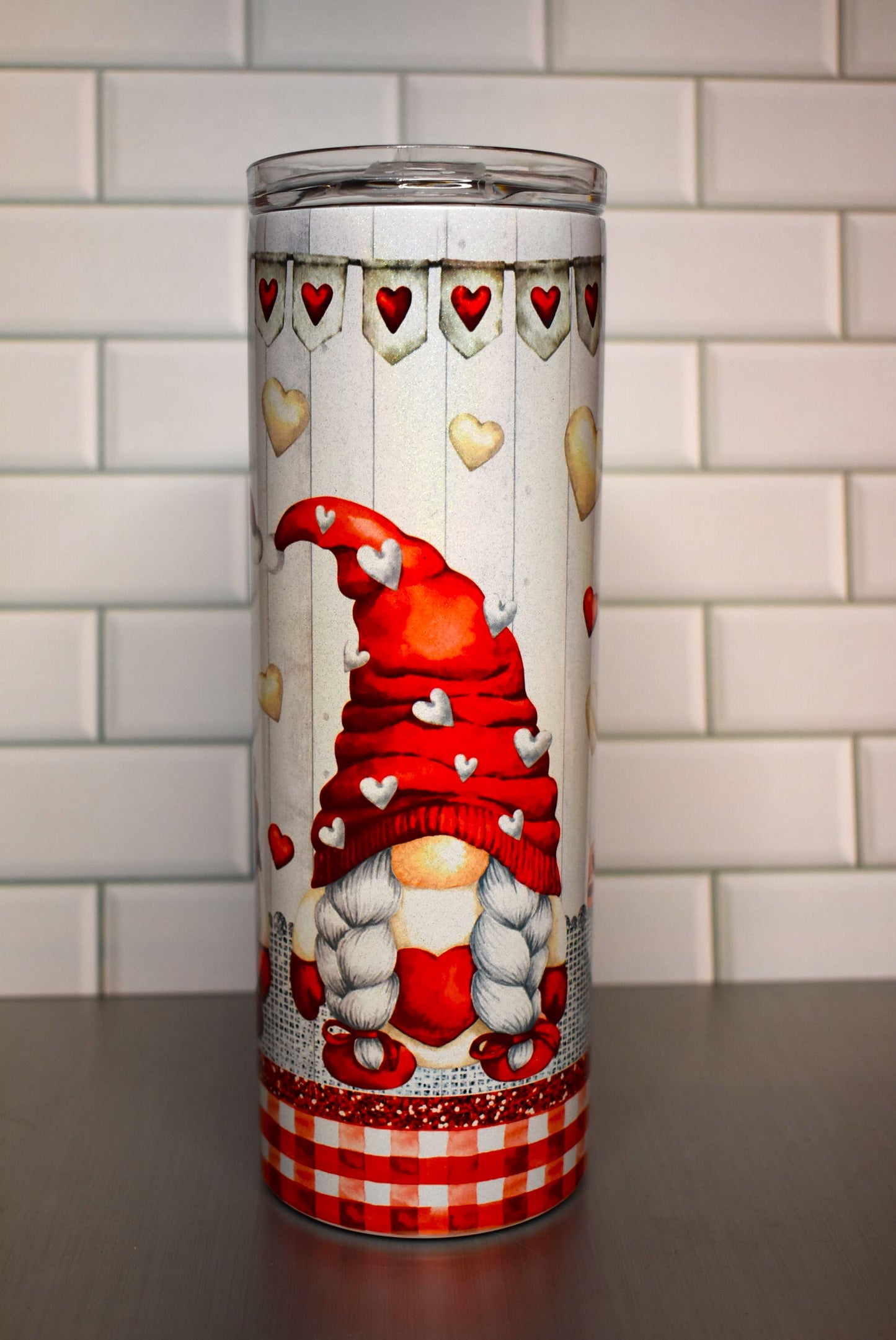 This 20 oz Makerflo Stainless Steel tumbler features a Gnome Love Couple design This love couple features red & white hearts floating all around with a heart banner circling the tumblers top.