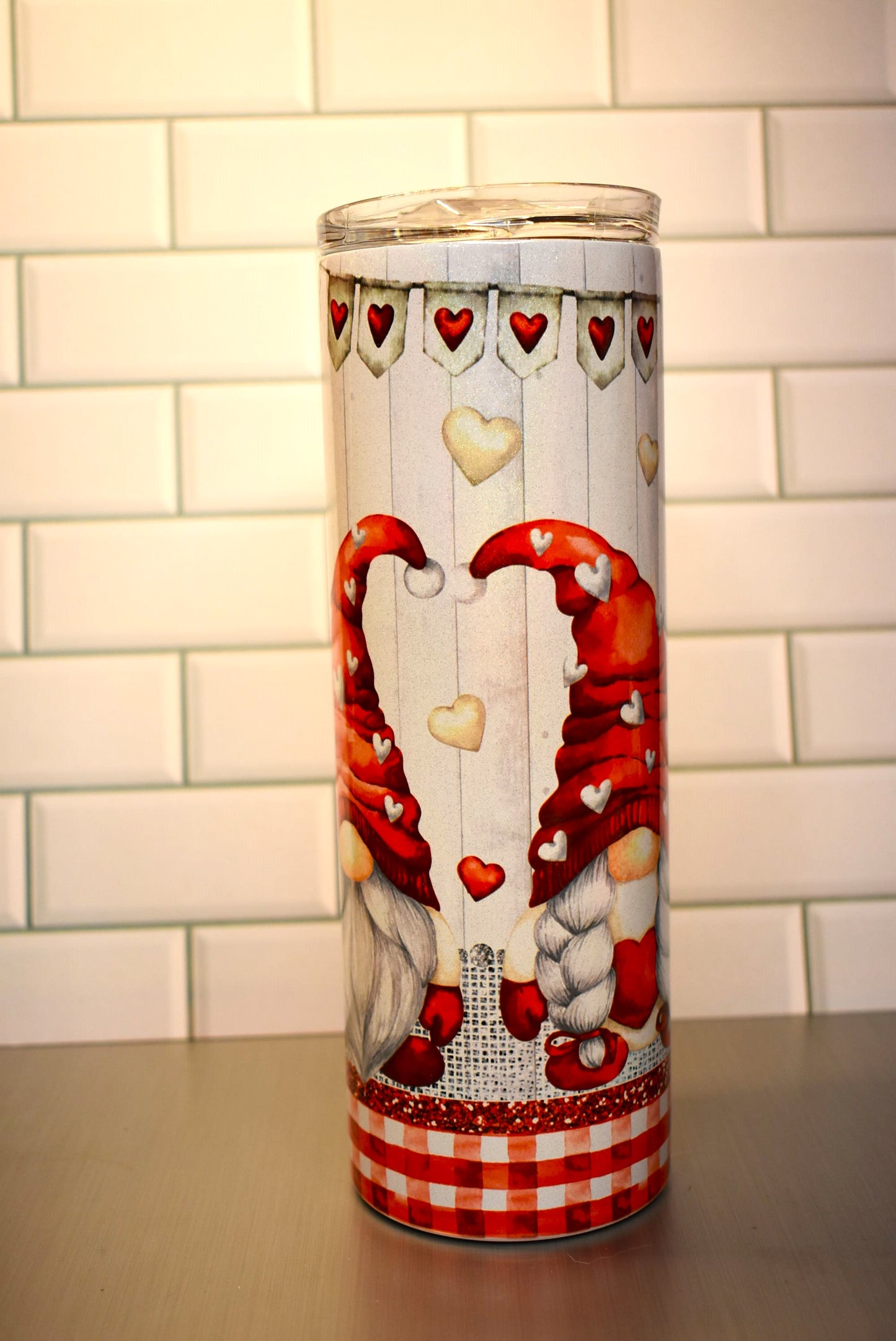 This 20 oz Makerflo Stainless Steel tumbler features a Gnome Love Couple design This love couple features red & white hearts floating all around with a heart banner circling the tumblers top.