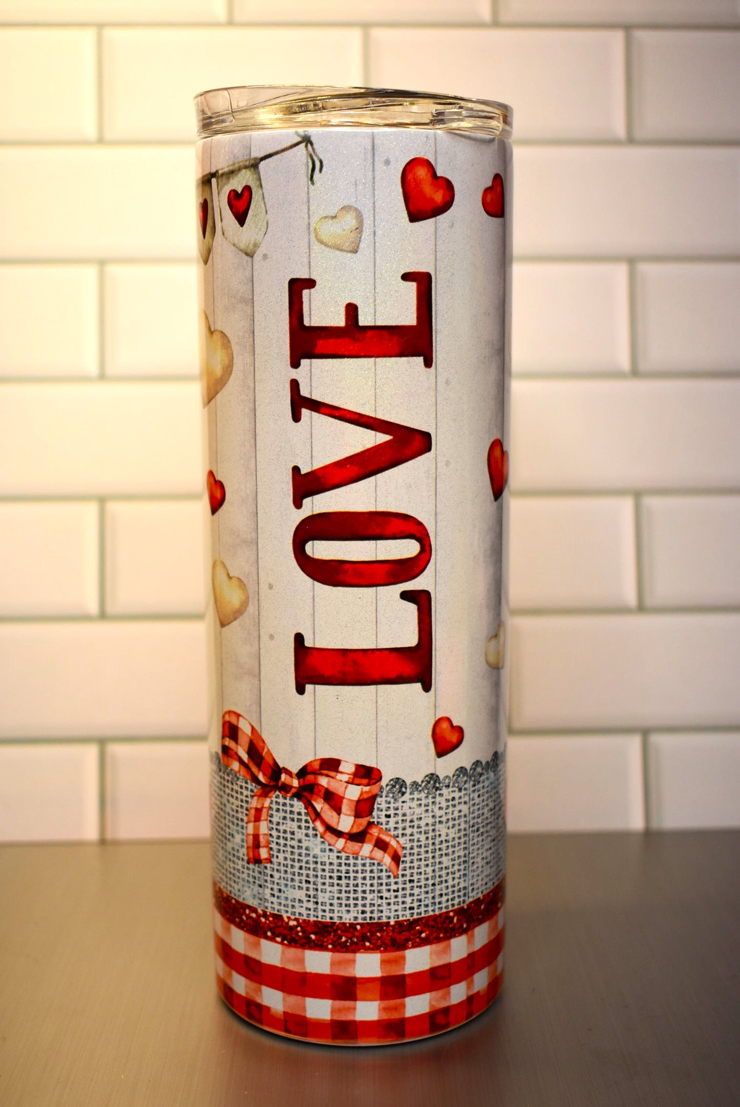 This 20 oz Makerflo Stainless Steel tumbler features a Gnome Love Couple design This love couple features red & white hearts floating all around with a heart banner circling the tumblers top.