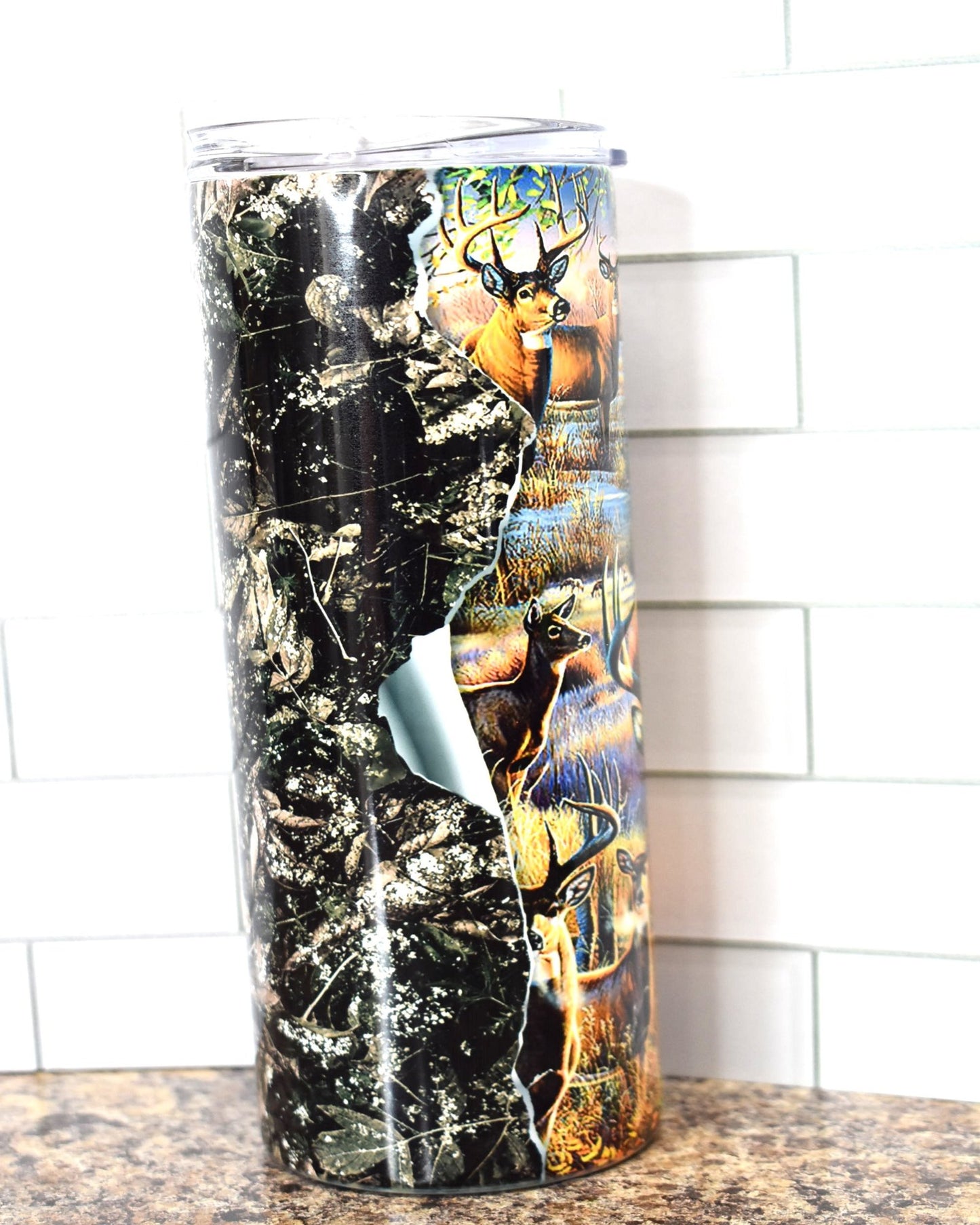 This 20 oz Stainless Steel tumbler feature a Big Whitetail Buck in various scenes that all appear to be tearing through the walls of the tumbler. It is double-walled, vacuum insulated, and features a clear sliding classic lid and clear straw. BPA free, this tumbler retains cold temperatures for 24+ hours and warmth for 8 hours.