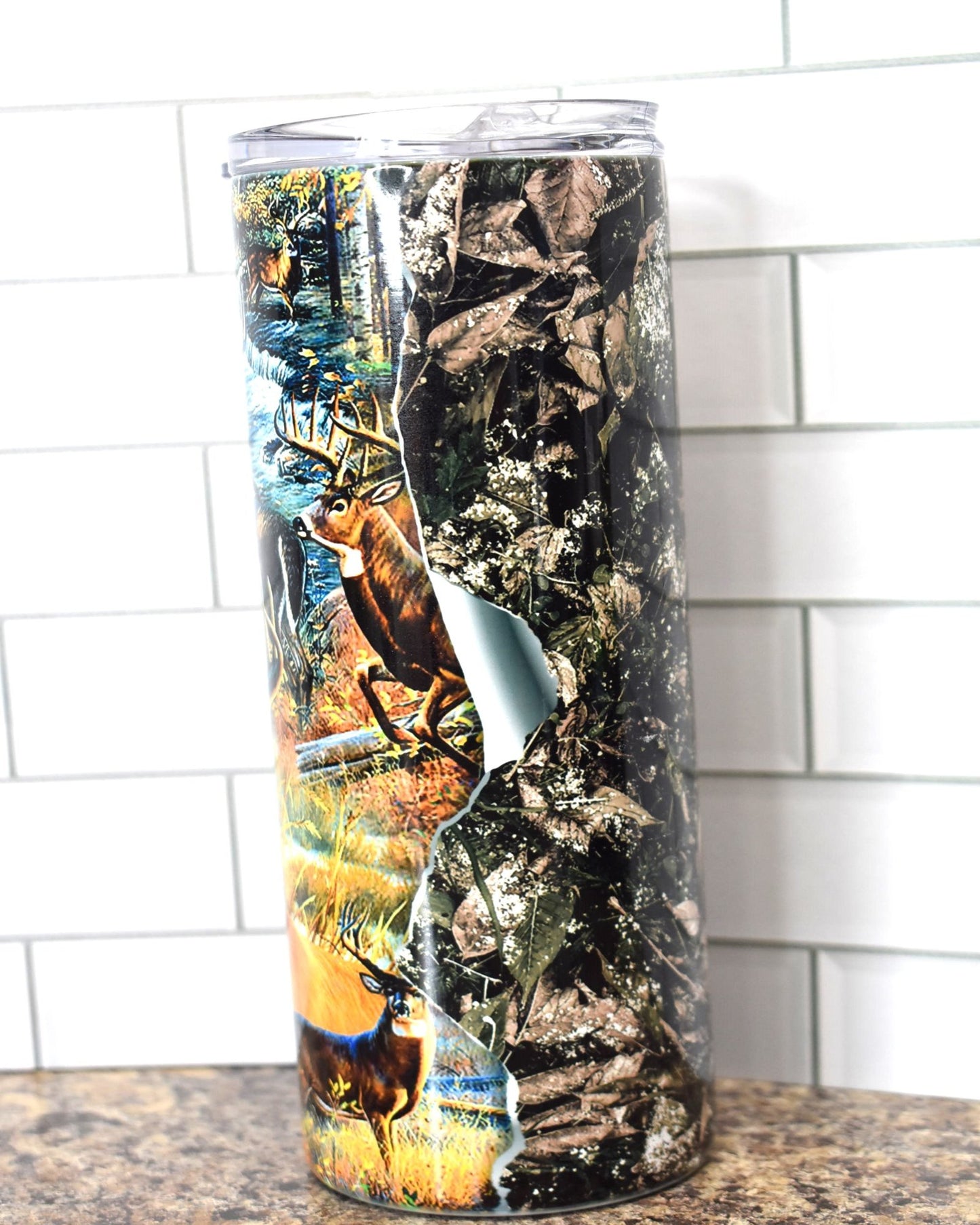 This 20 oz Stainless Steel tumbler feature a Big Whitetail Buck in various scenes that all appear to be tearing through the walls of the tumbler. It is double-walled, vacuum insulated, and features a clear sliding classic lid and clear straw. BPA free, this tumbler retains cold temperatures for 24+ hours and warmth for 8 hours.